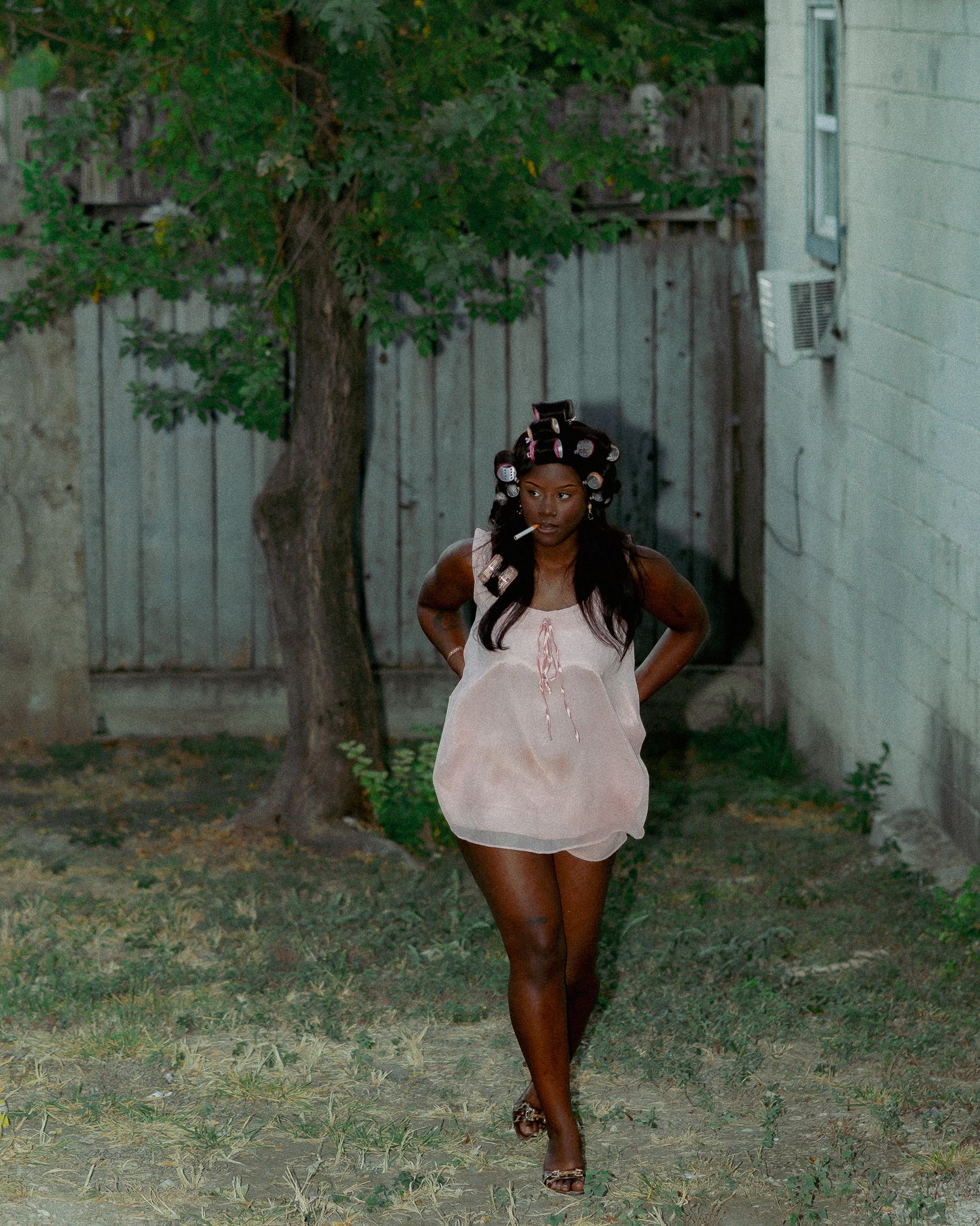 A series of artistic outdoor photos showing someone posing in a pink top against a concrete wall and trees.