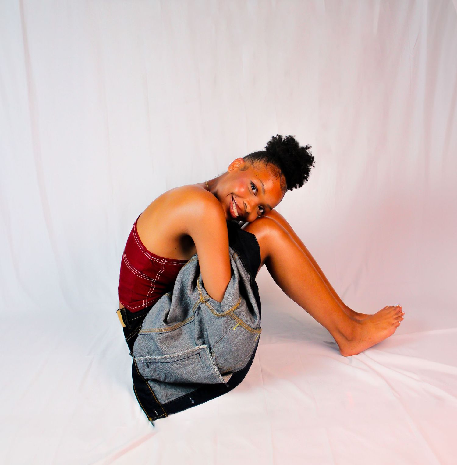 Artistic photo series showing relaxed poses in gray outfit against white background.