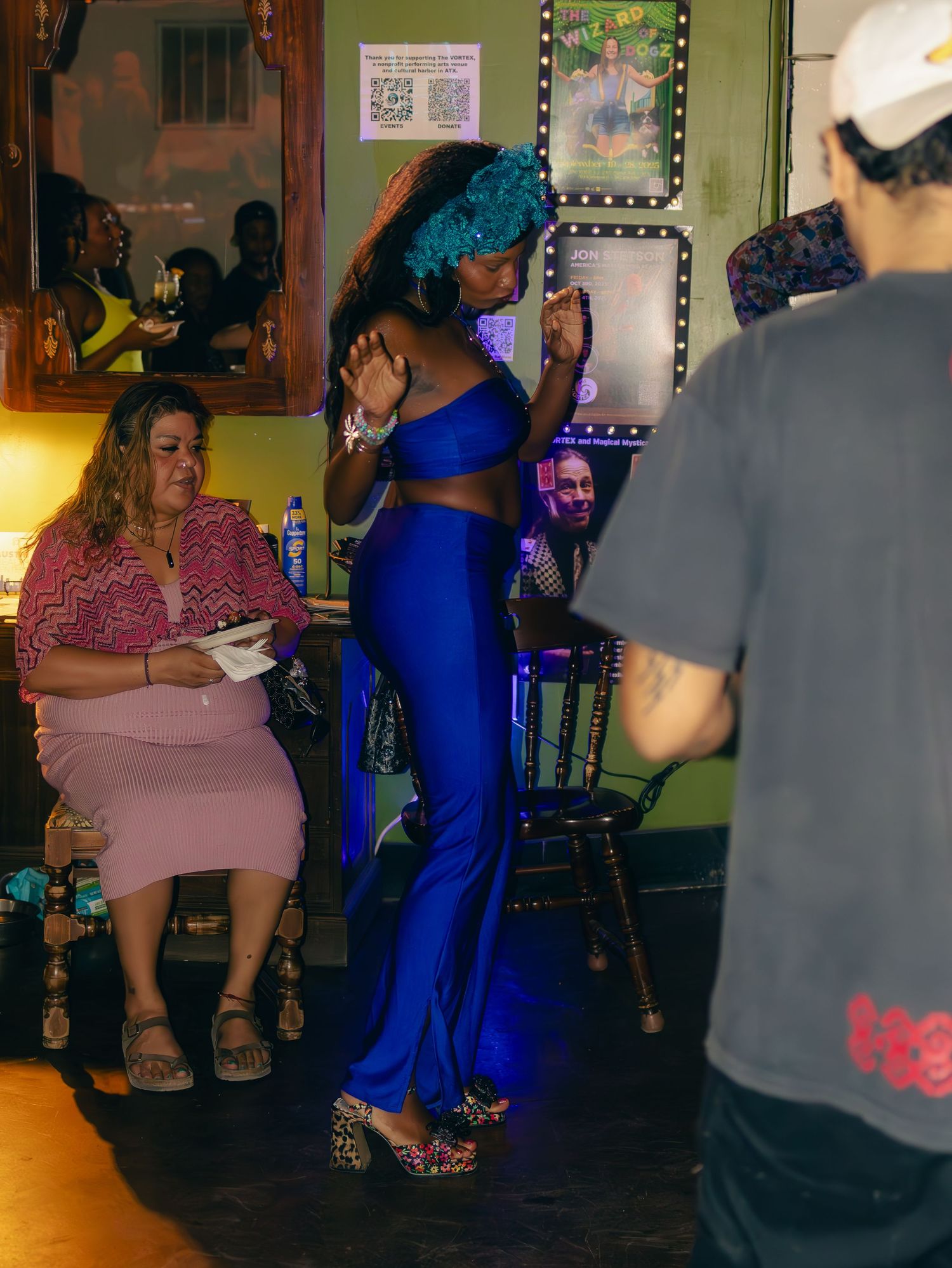 People socializing in a colorfully decorated indoor venue space.