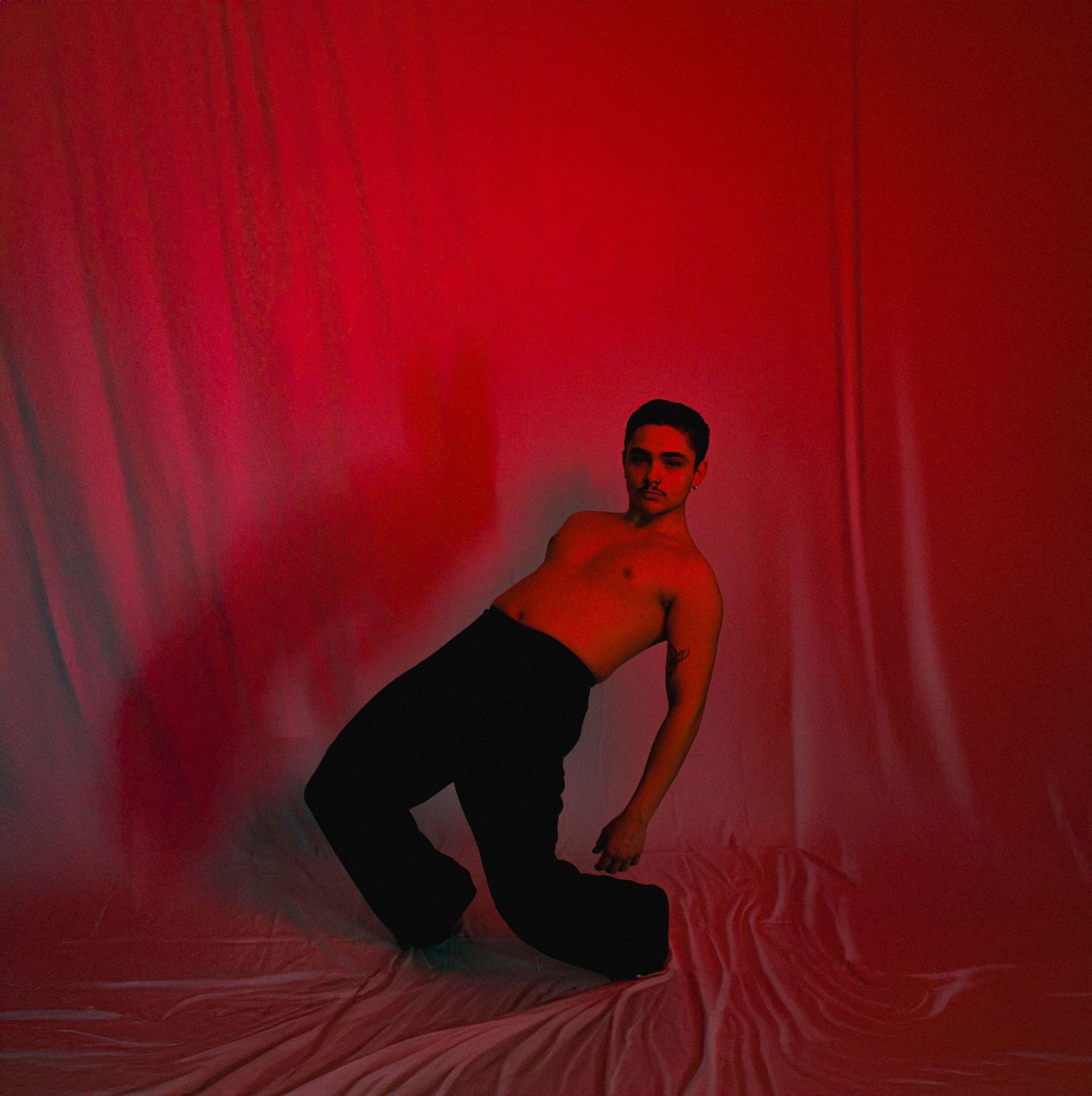 Artistic silhouette sequence against red backdrop shows flowing movement and dance poses.