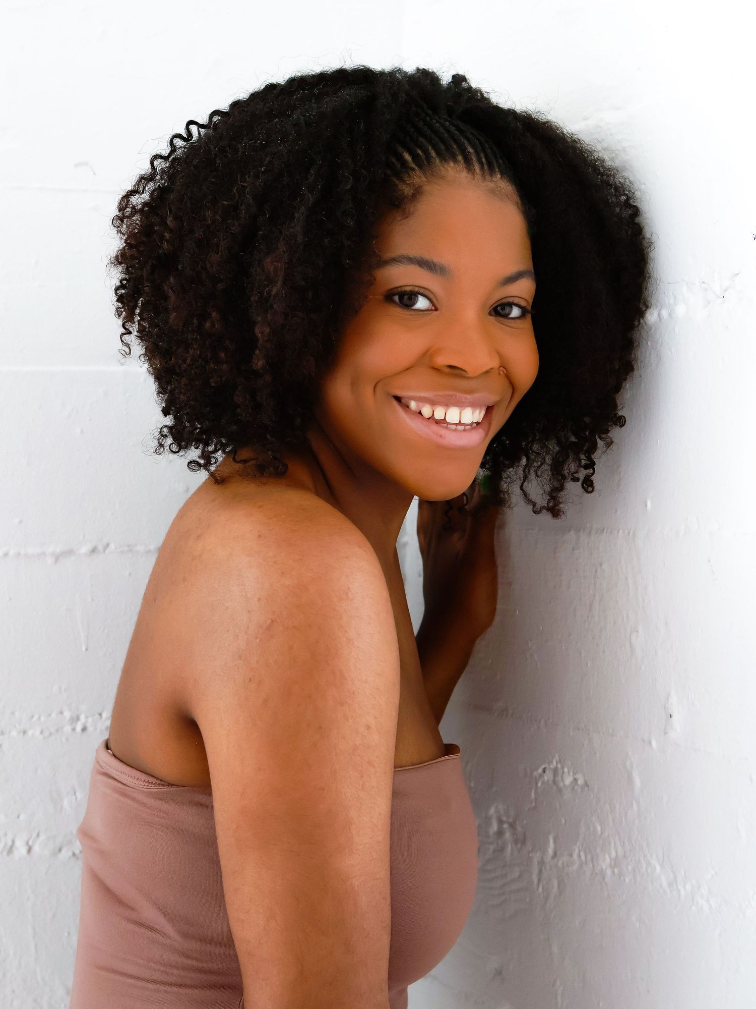 Elegant portrait series showing graceful poses against white studio wall.