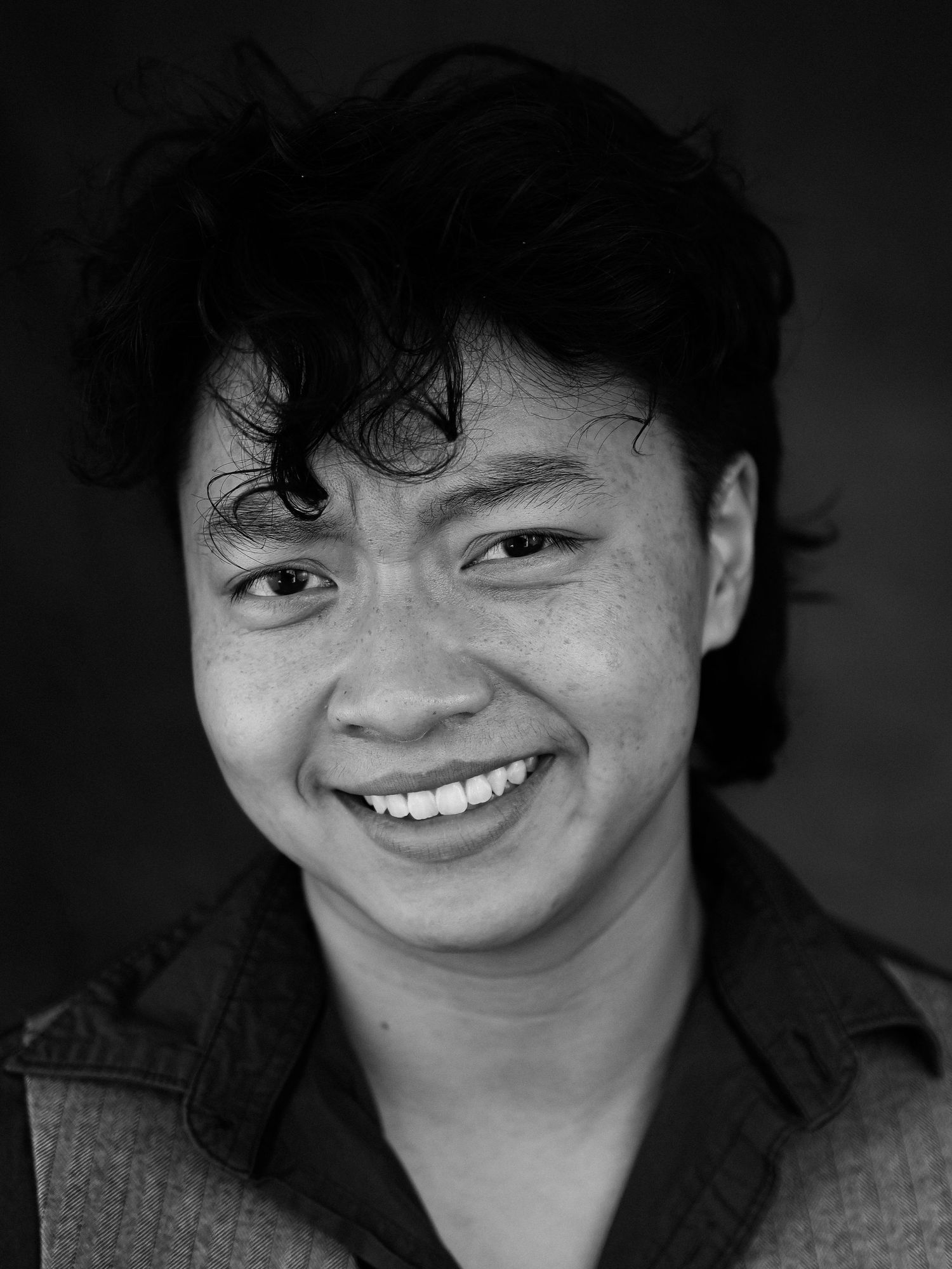 Black and white portrait with genuine smile wearing casual attire.