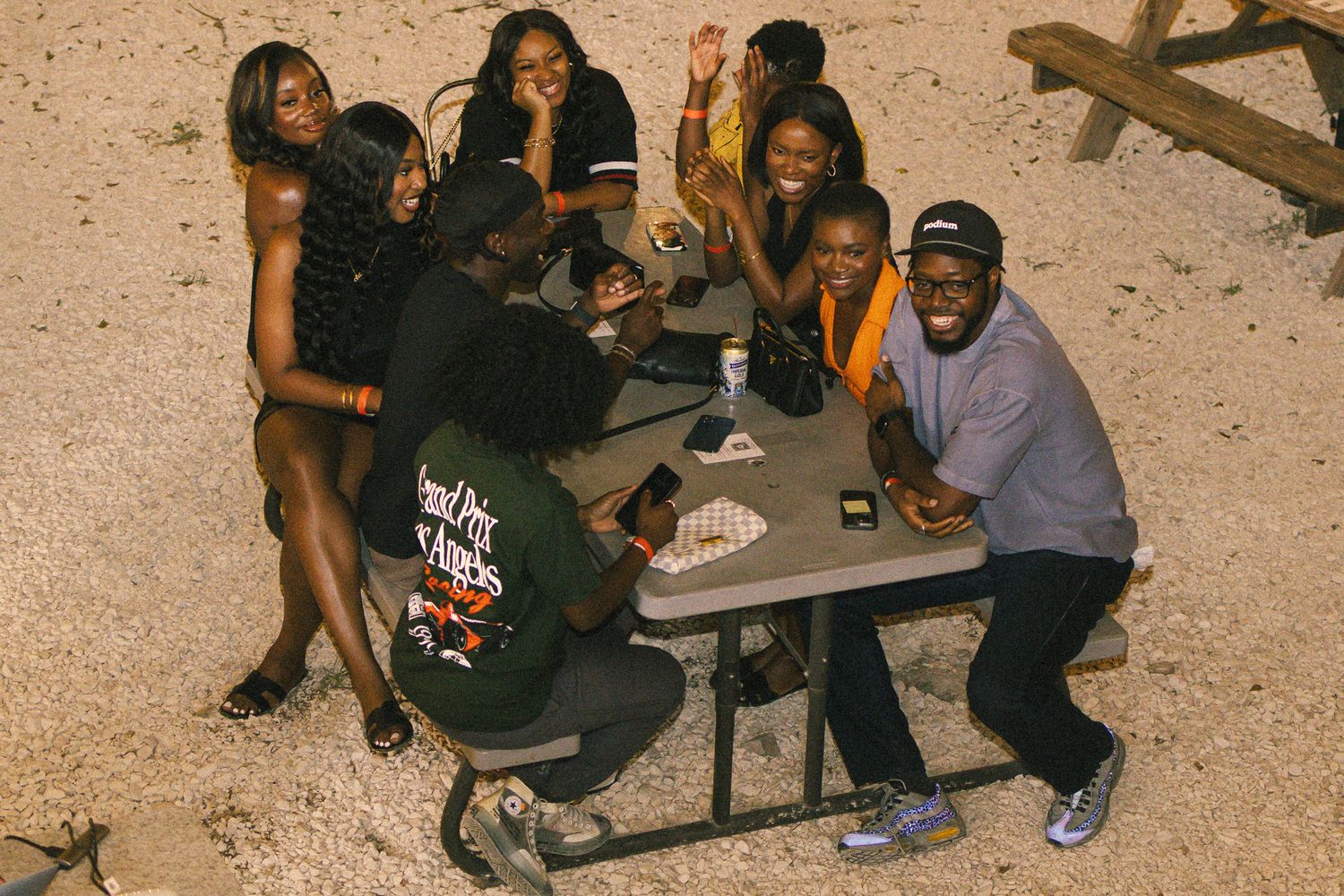 Group enjoying conversation at outdoor seating area in the evening.