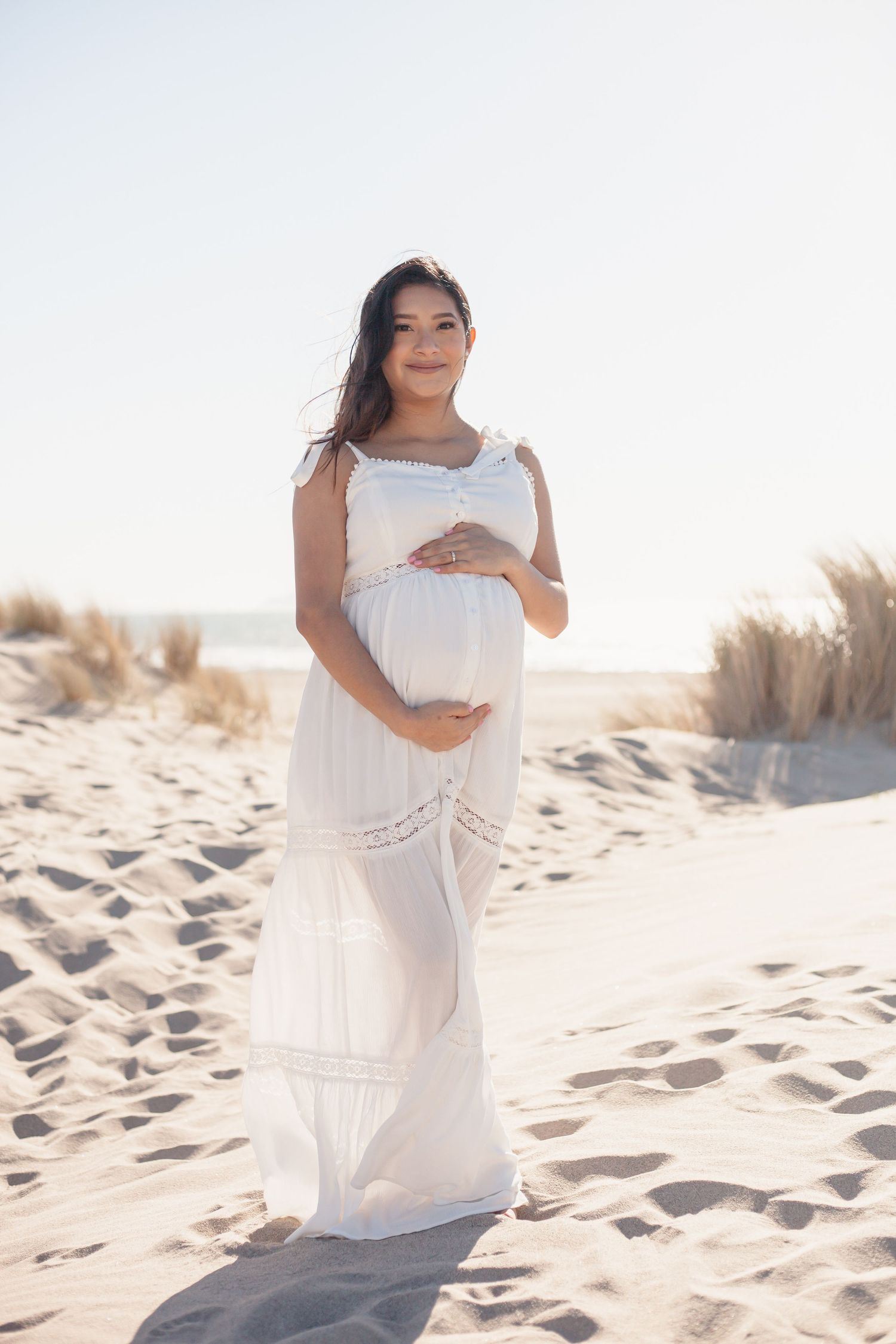 Maternity photos of expecting mom on Oxnard Beach, California.