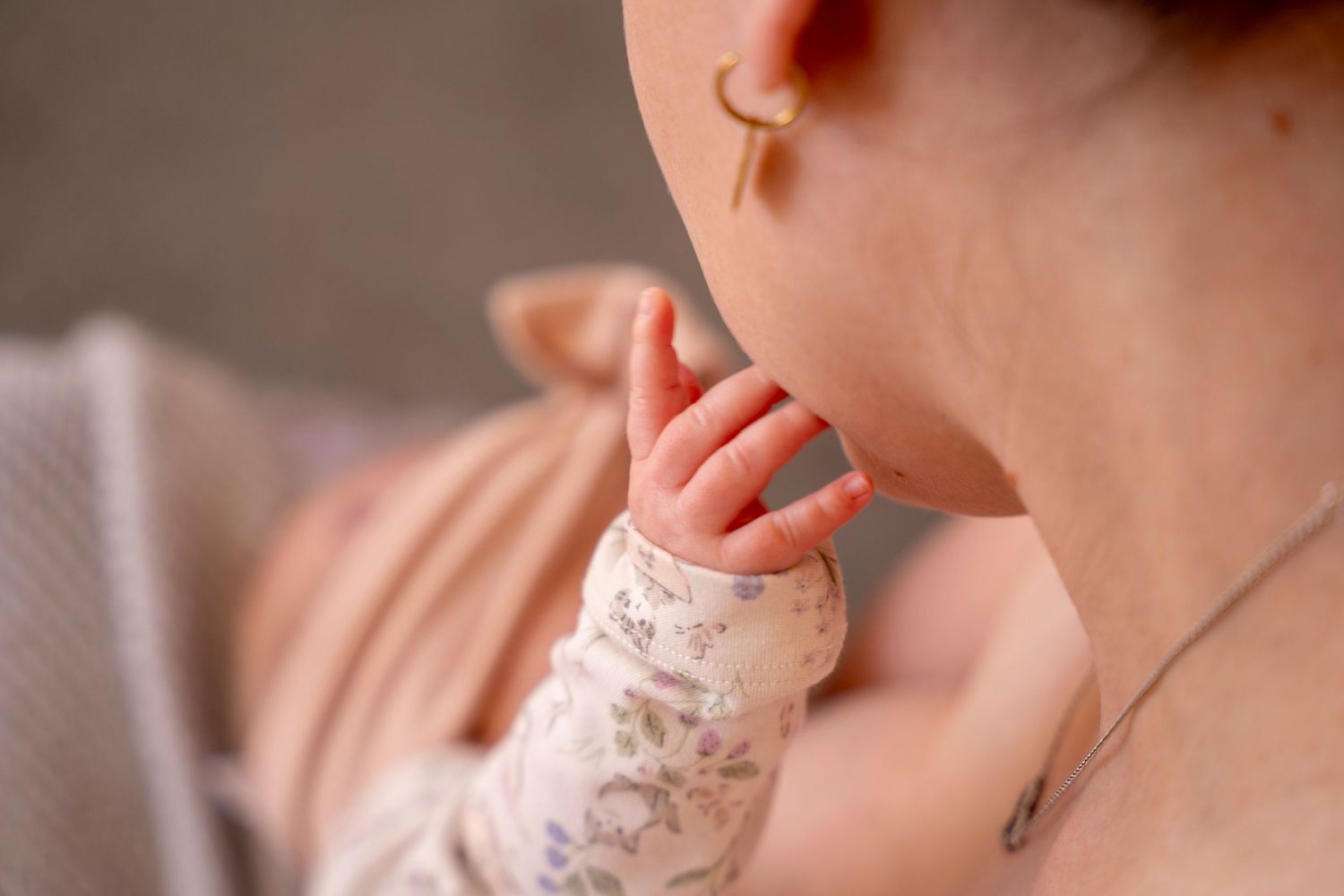 baby stoking mothers face while feeding