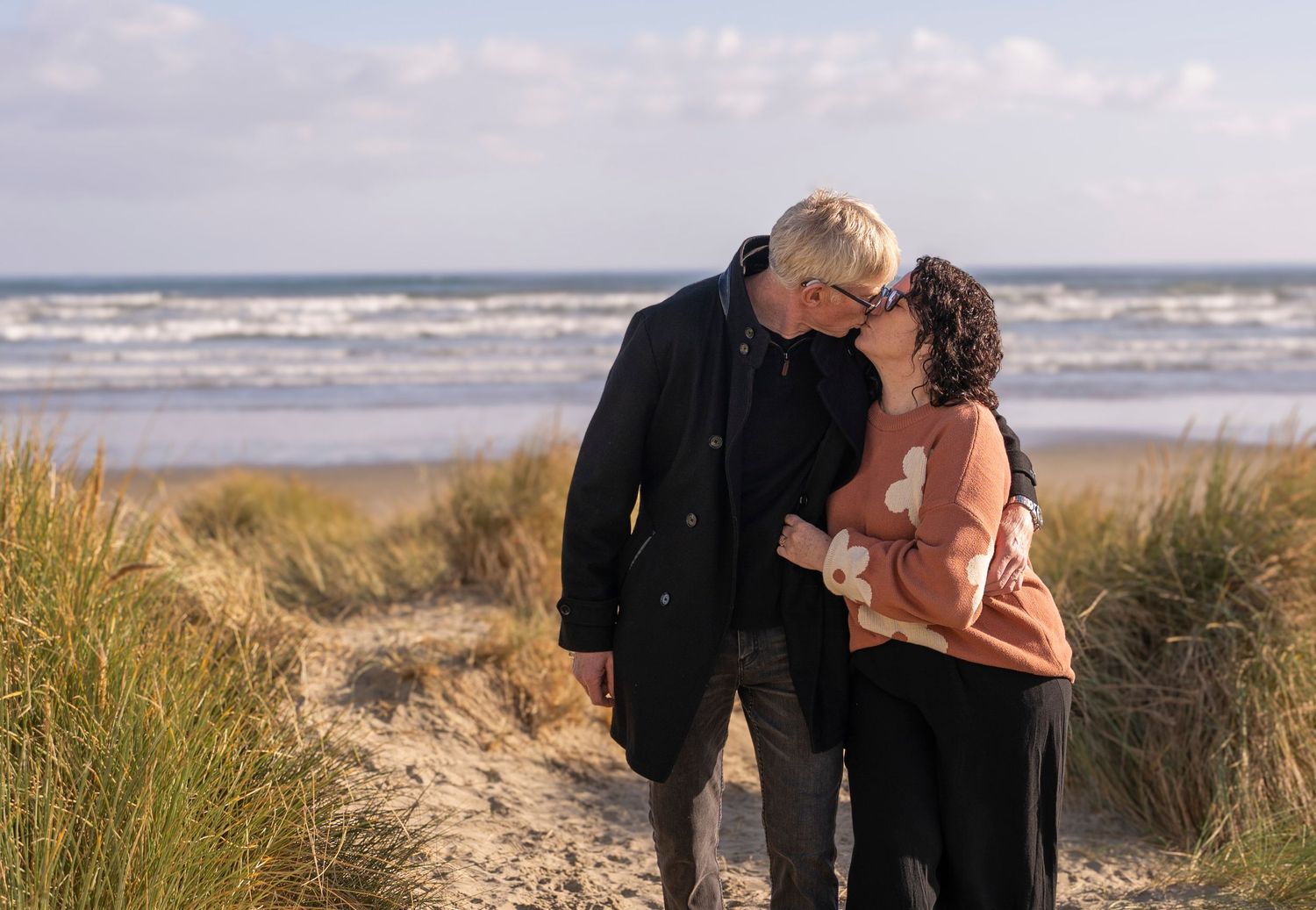 two people kissing at the beach