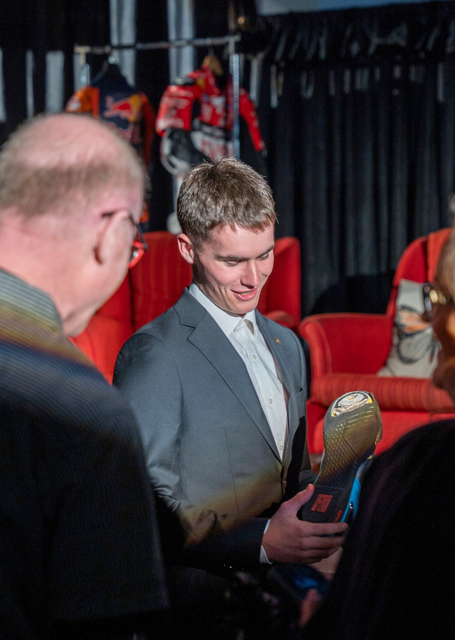 Grid Talk gala person holding motobike shoe