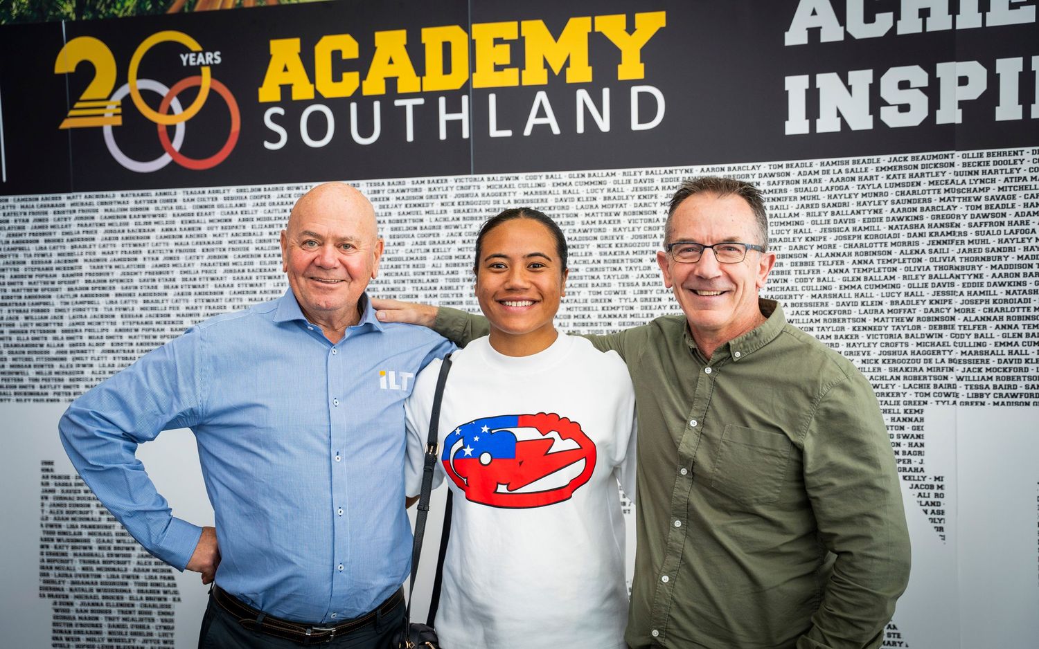 three people pictured in front of a wall for ILT Academy Southland's 20th celebrations
