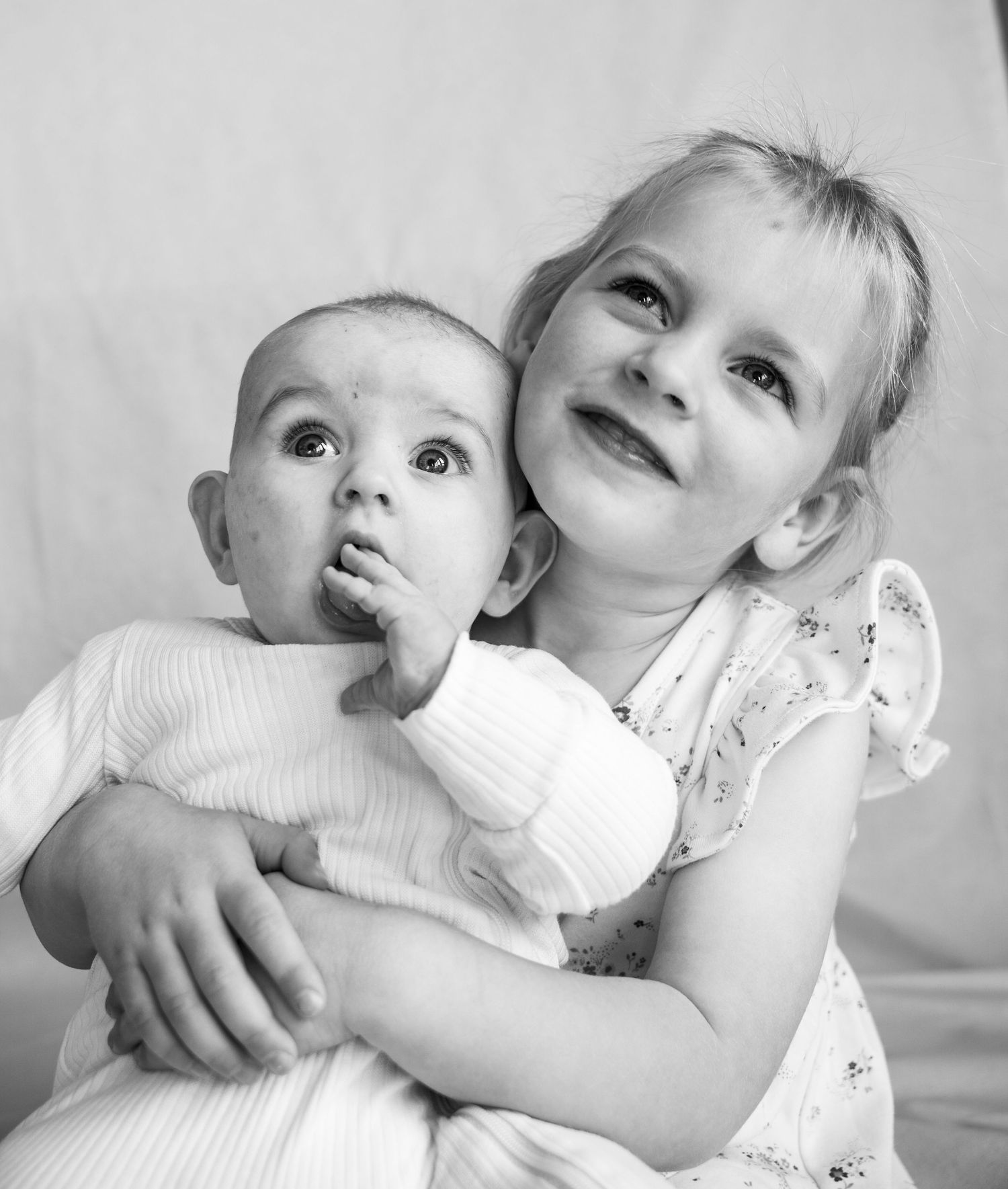 two kids hugging black and white image