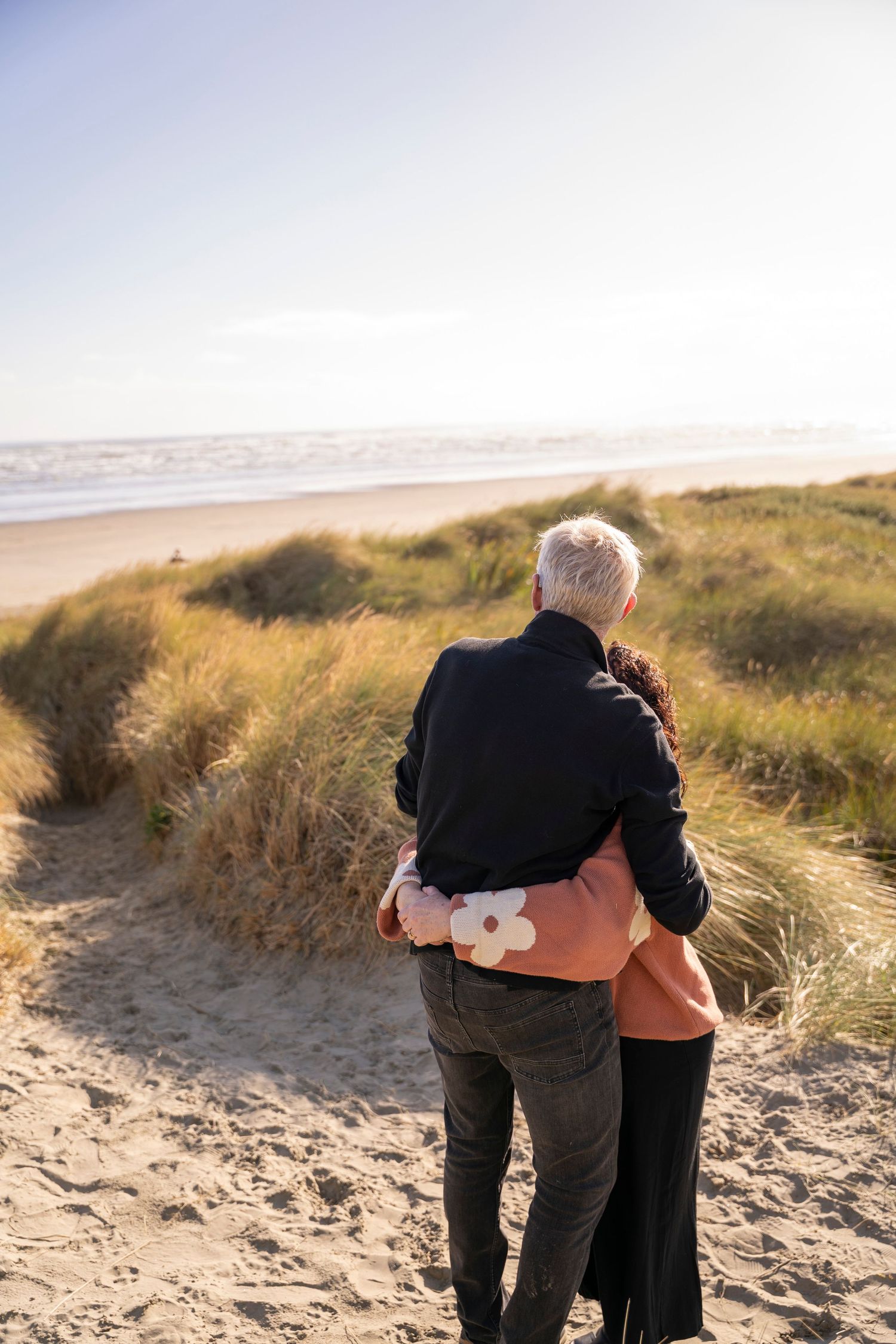 people hugging at the beach