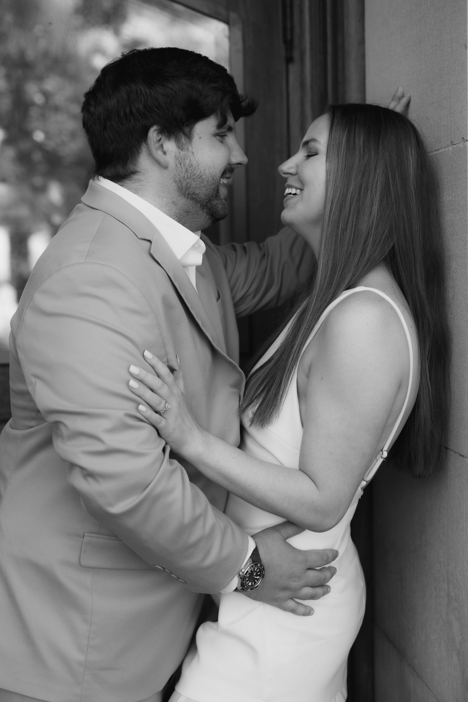 A romantic black and white photo sequence shows a couple in wedding attire sharing intimate moments against a wall.