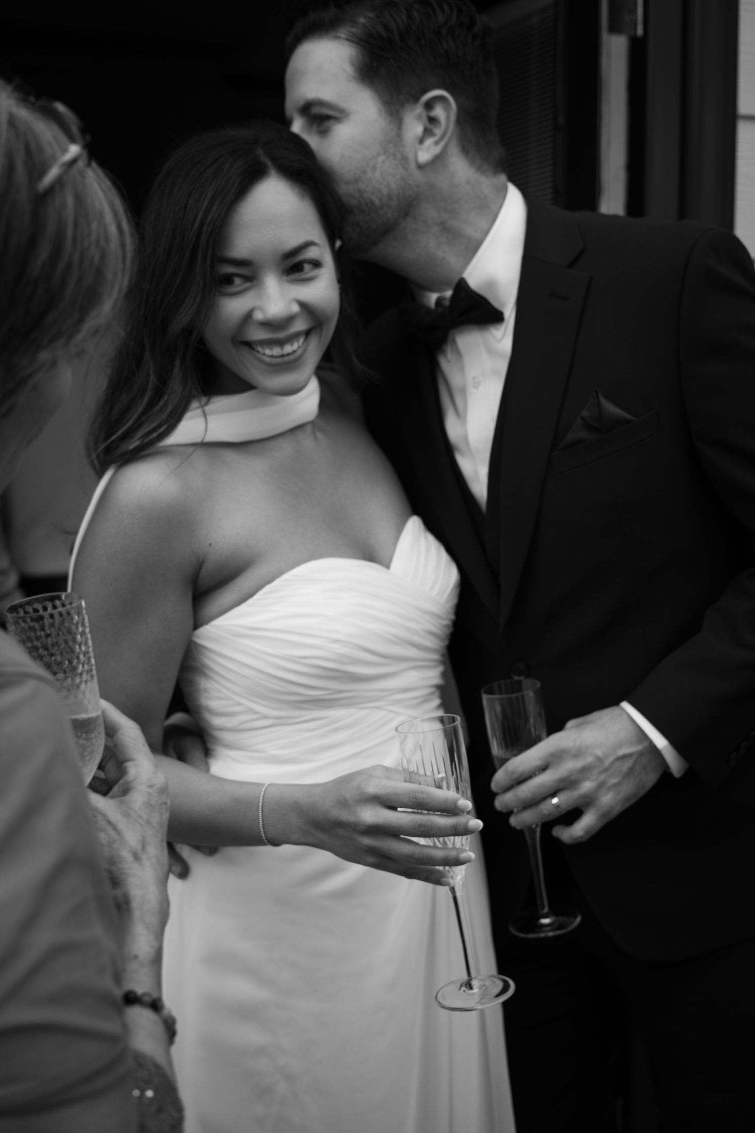 Elegant celebration with guests in formal attire enjoying drinks and conversation.