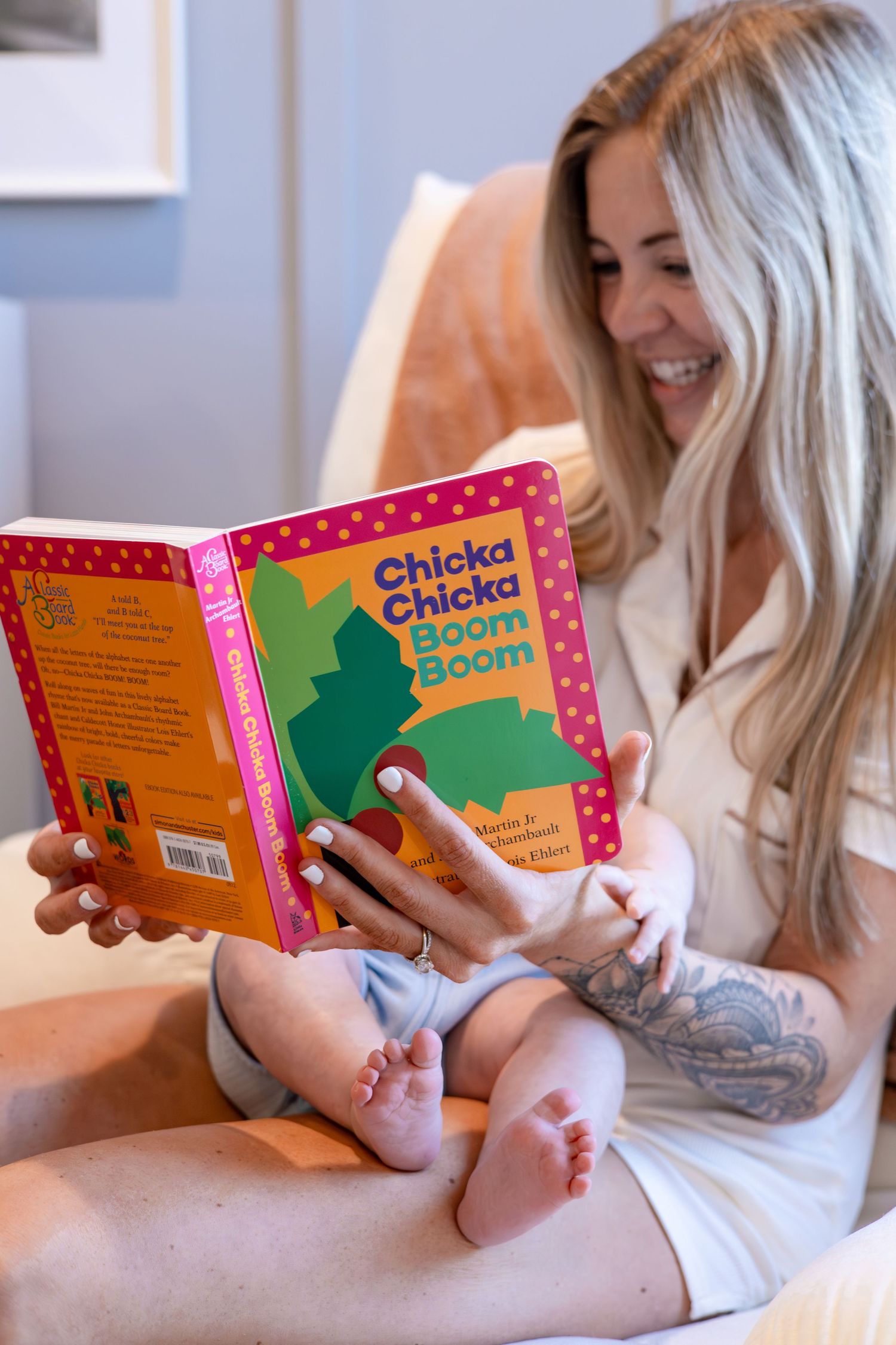 Reading a Chicka Chicka children's book while relaxing on comfortable bedding.