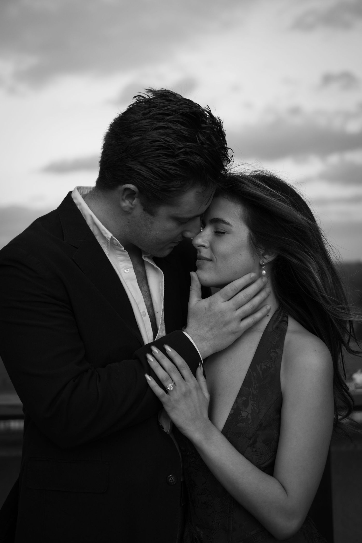 Black and white series of tender romantic moments between couple on rooftop.