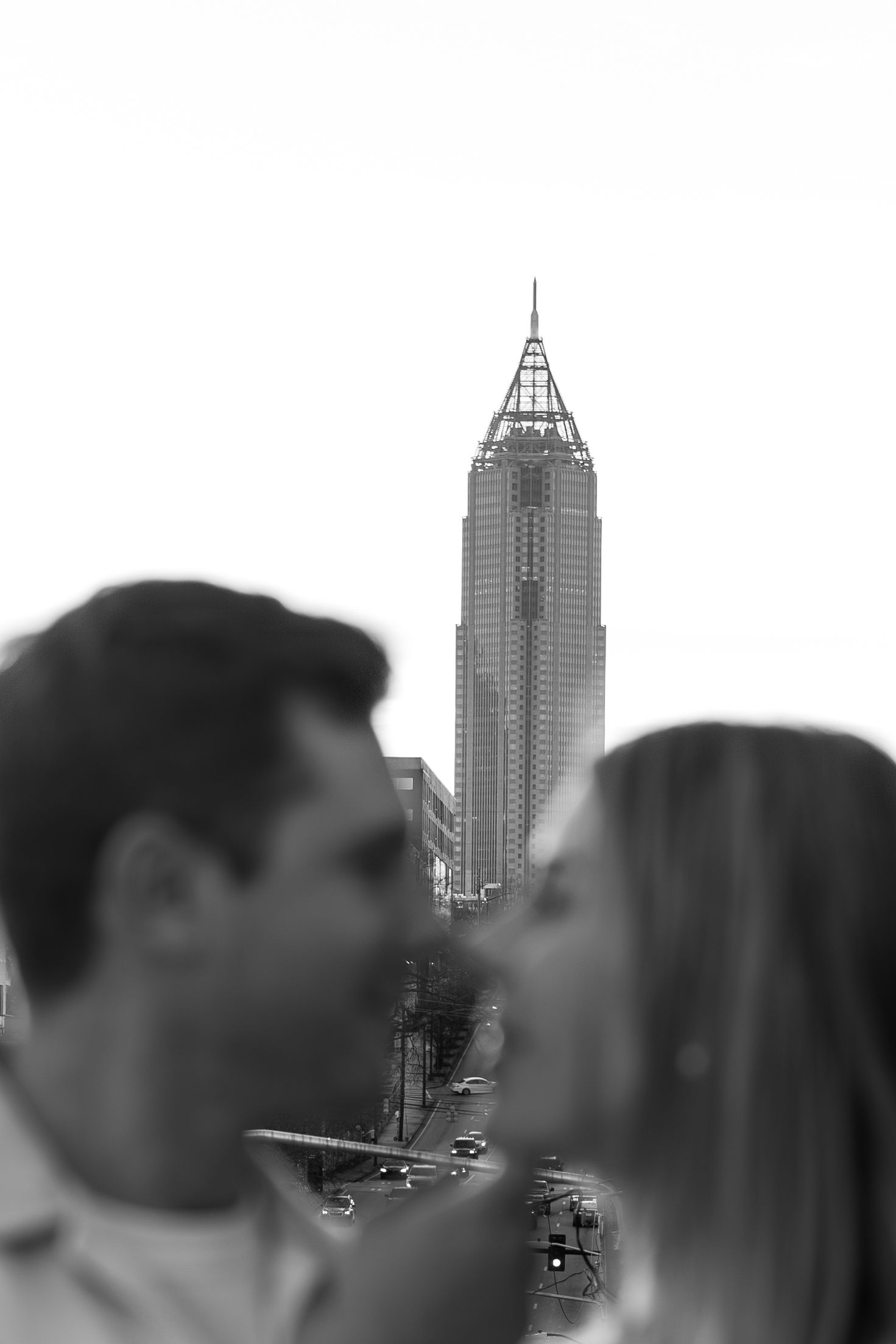 Silhouetted figures against urban skyline with tall buildings in background.