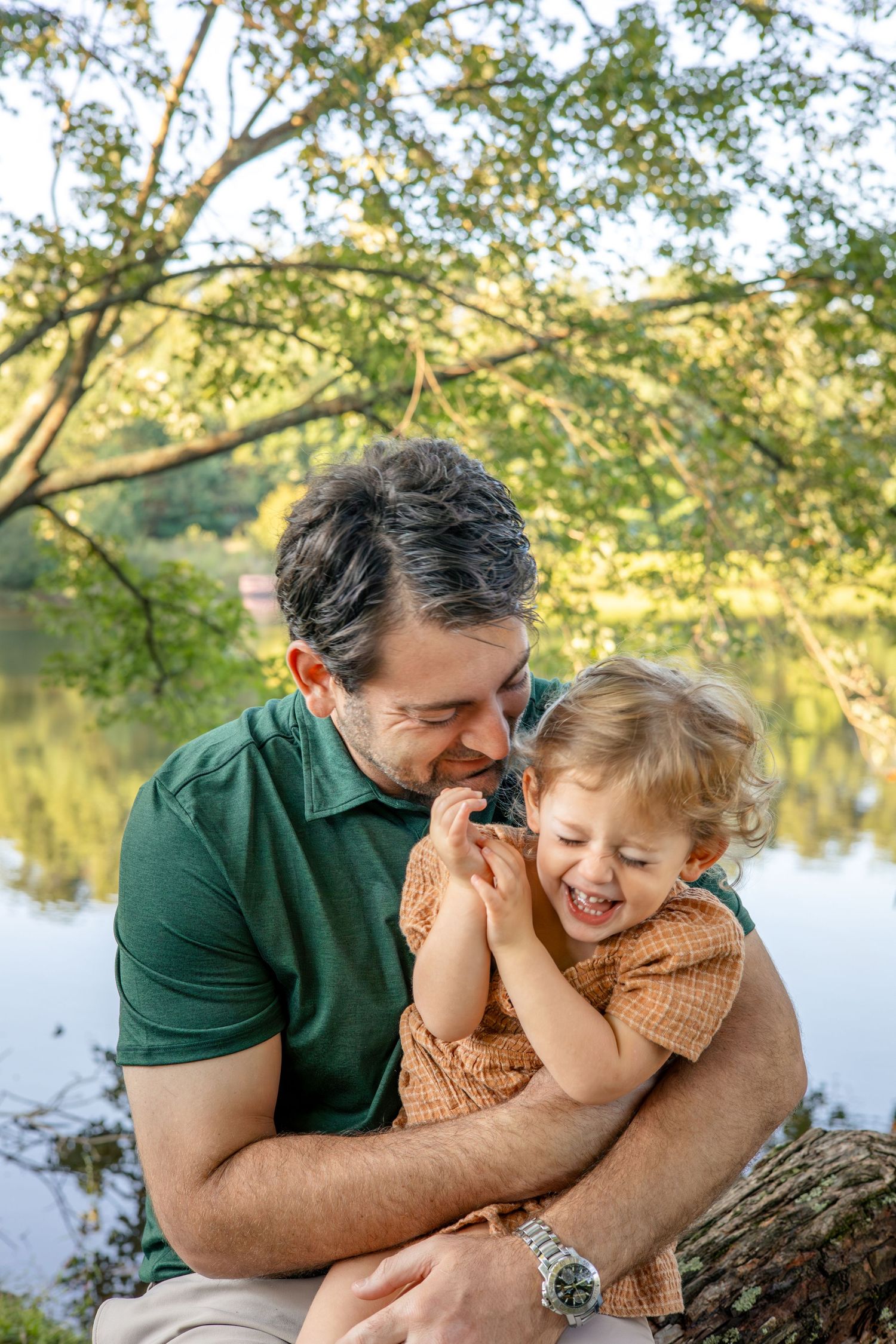A heartwarming moment shared between parent and child by the lake.