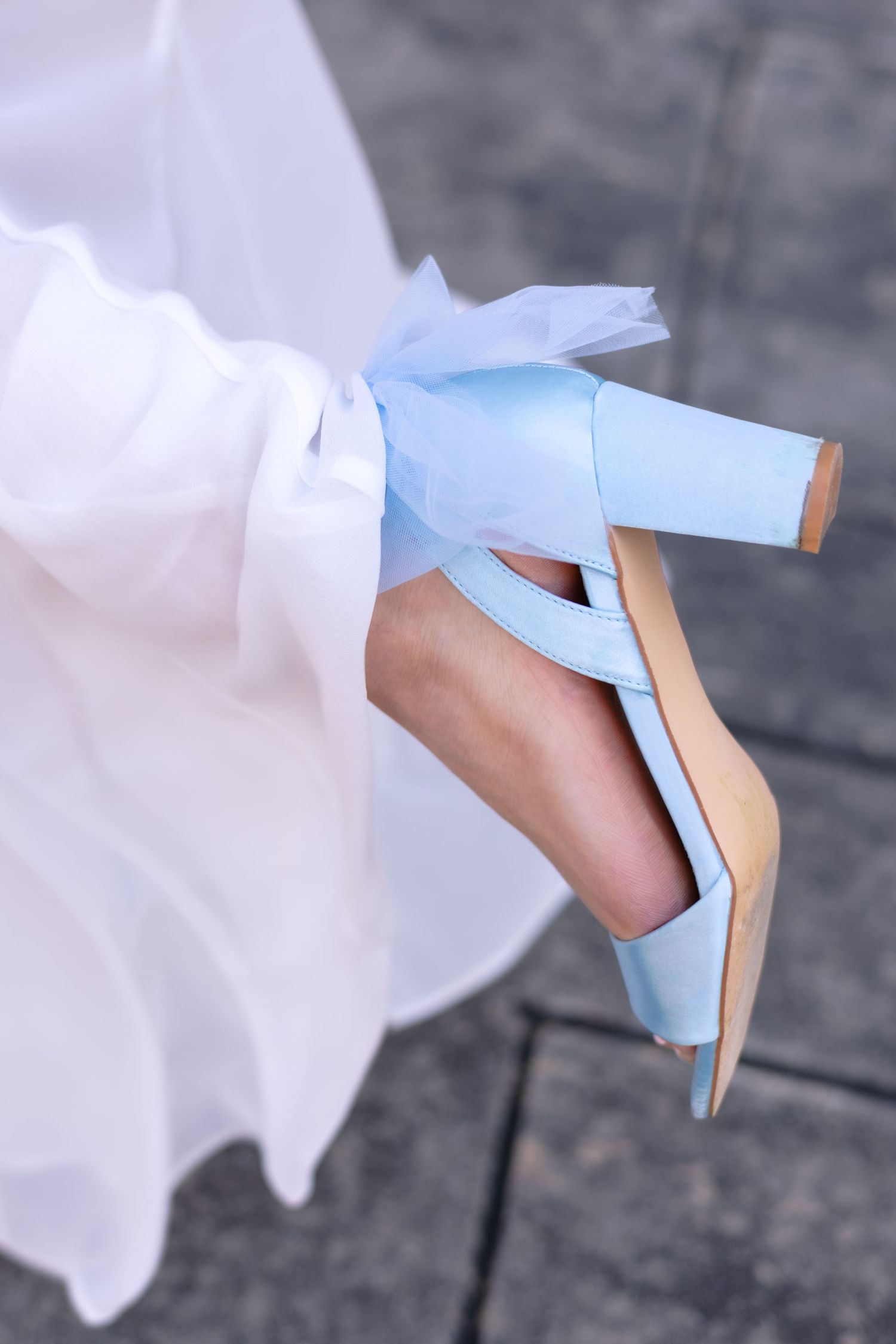 The image shows a hand holding a blue and white paper airplane, suggesting creativity and playfulness.