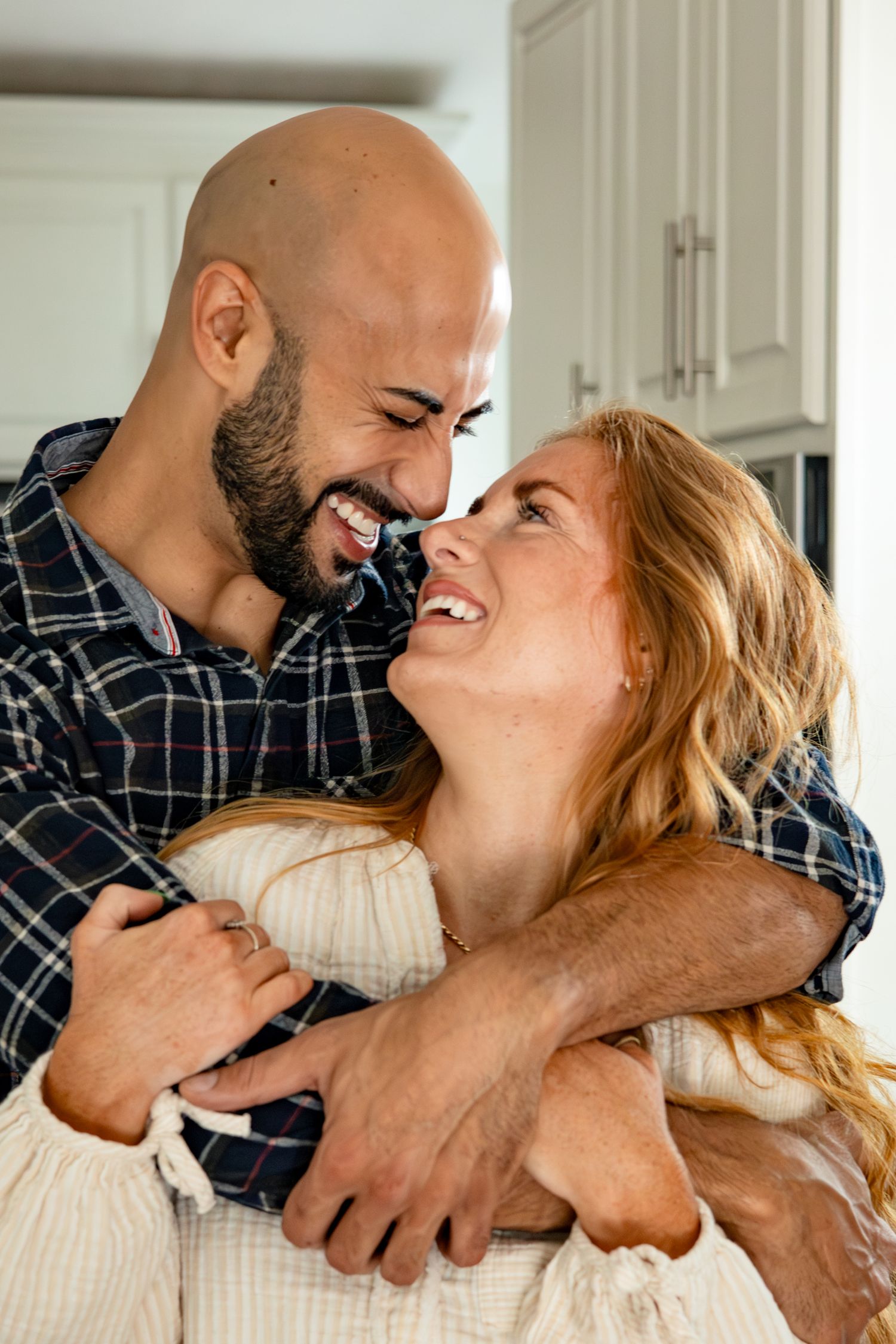 Close-up shots of a couple sharing laughter and intimate moments in their kitchen.