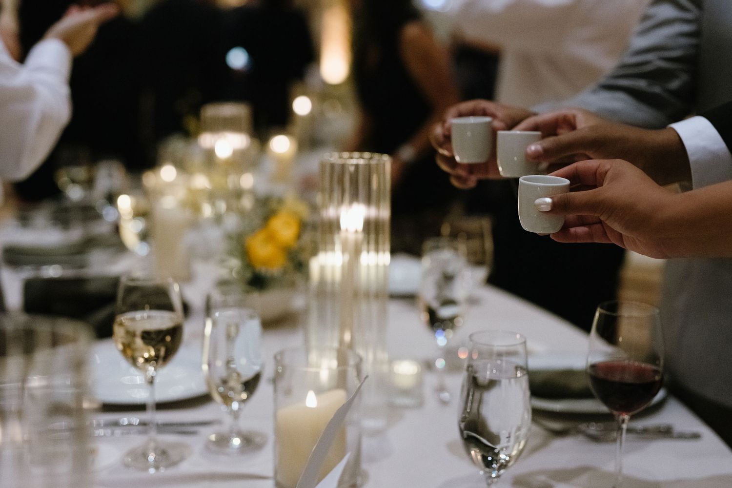 Formal dinner setting with wine glasses and place settings at a celebration.
