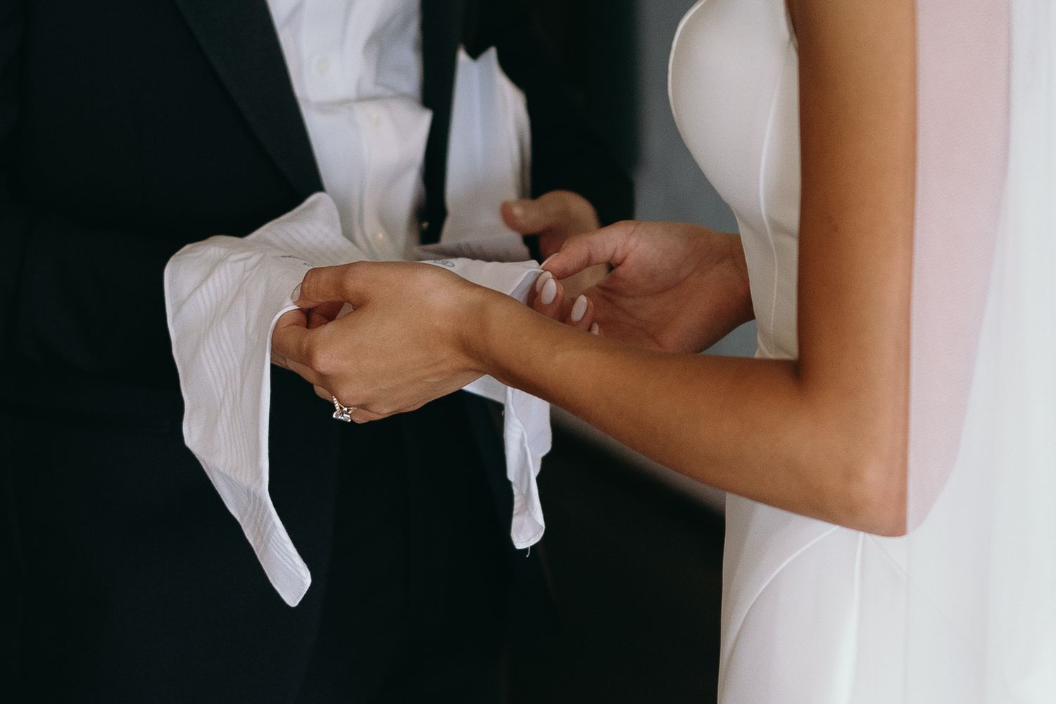 Close-up details of wedding dress preparations and final touches.