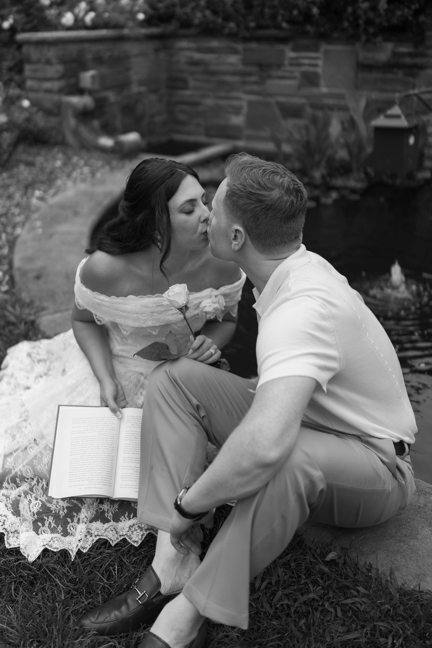 A romantic sequence of black and white photos showing a couple embracing and kissing in a garden setting.