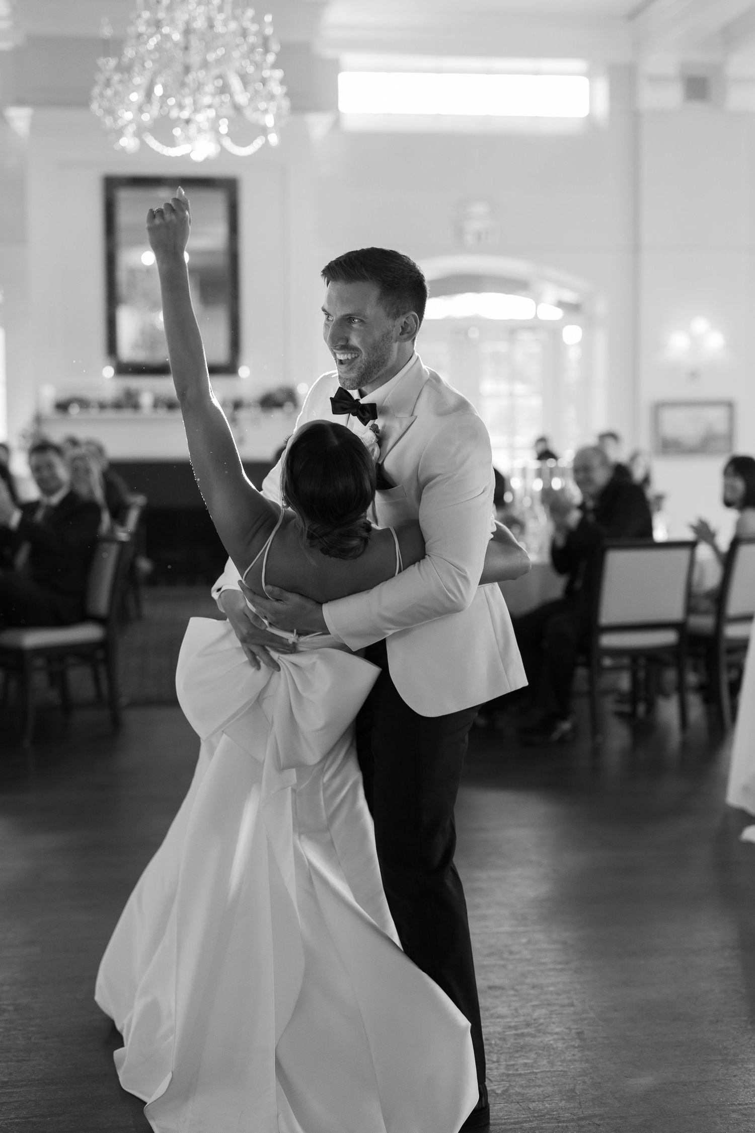 Black and white photo of couple dancing with dramatic dip move.
