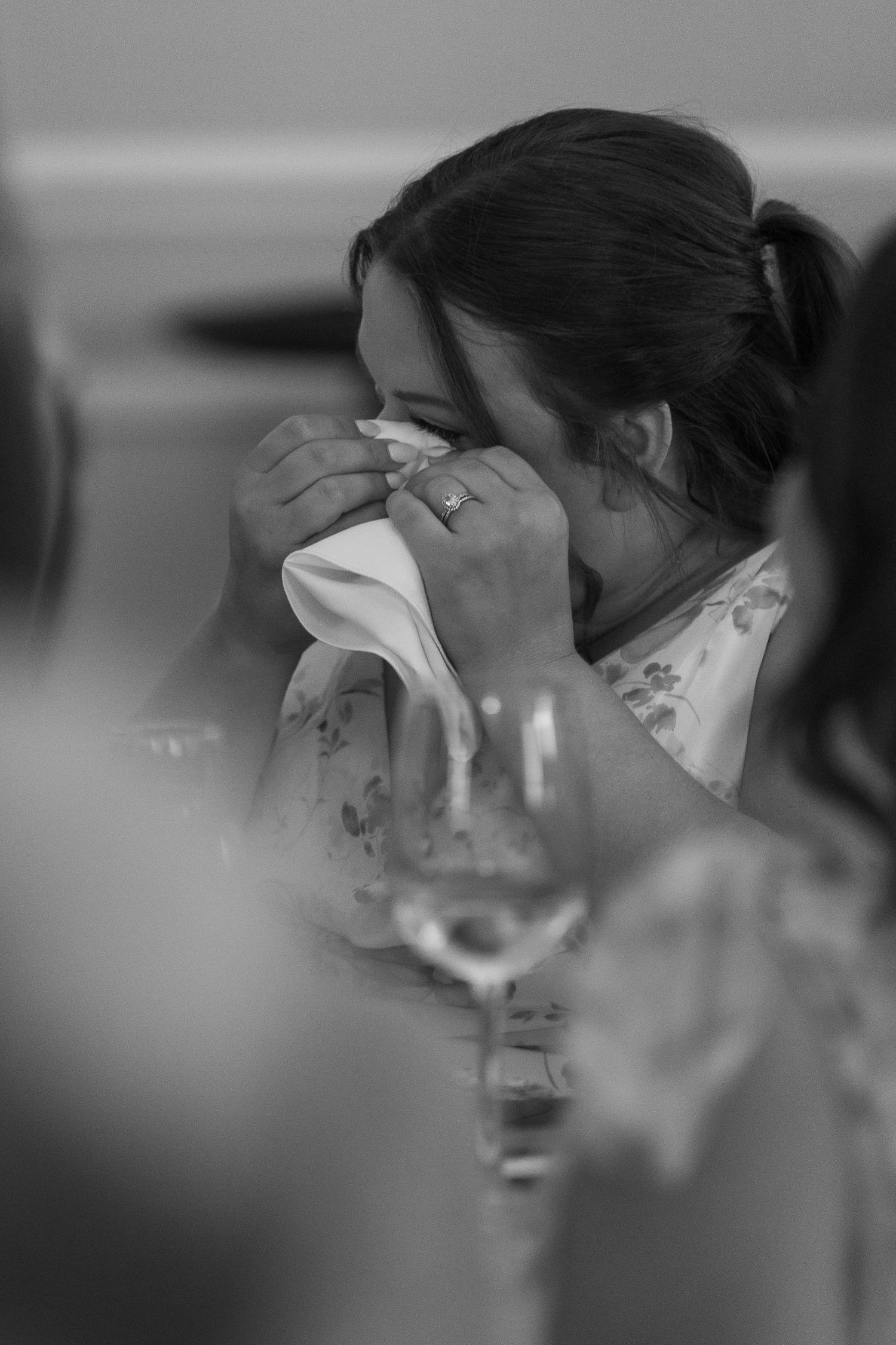 Black and white series of profile shots showing a person enjoying a drink through a wine glass against a light background.