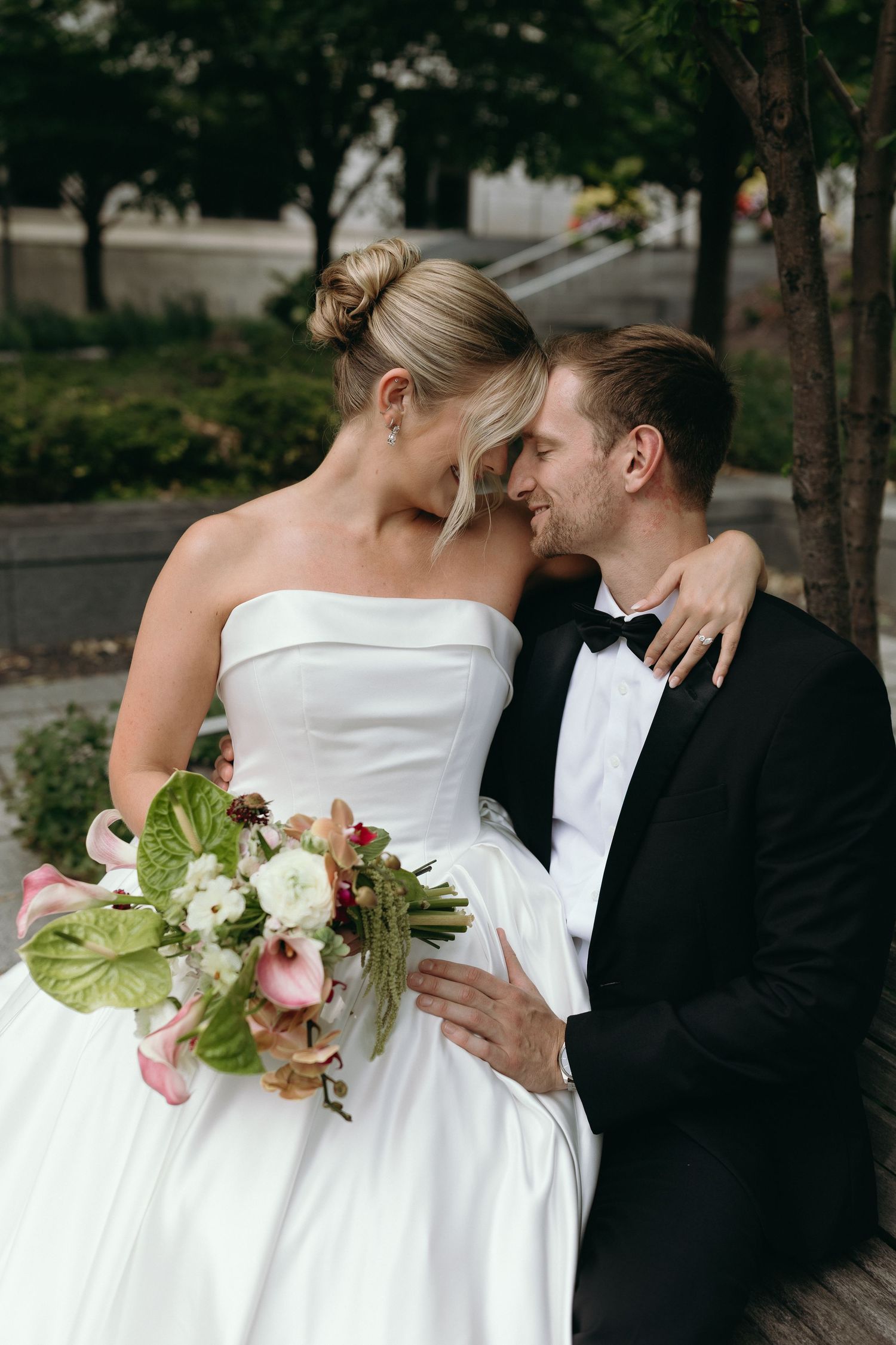 A romantic wedding sequence showing a couple in formal attire sharing intimate moments with white floral bouquet details.