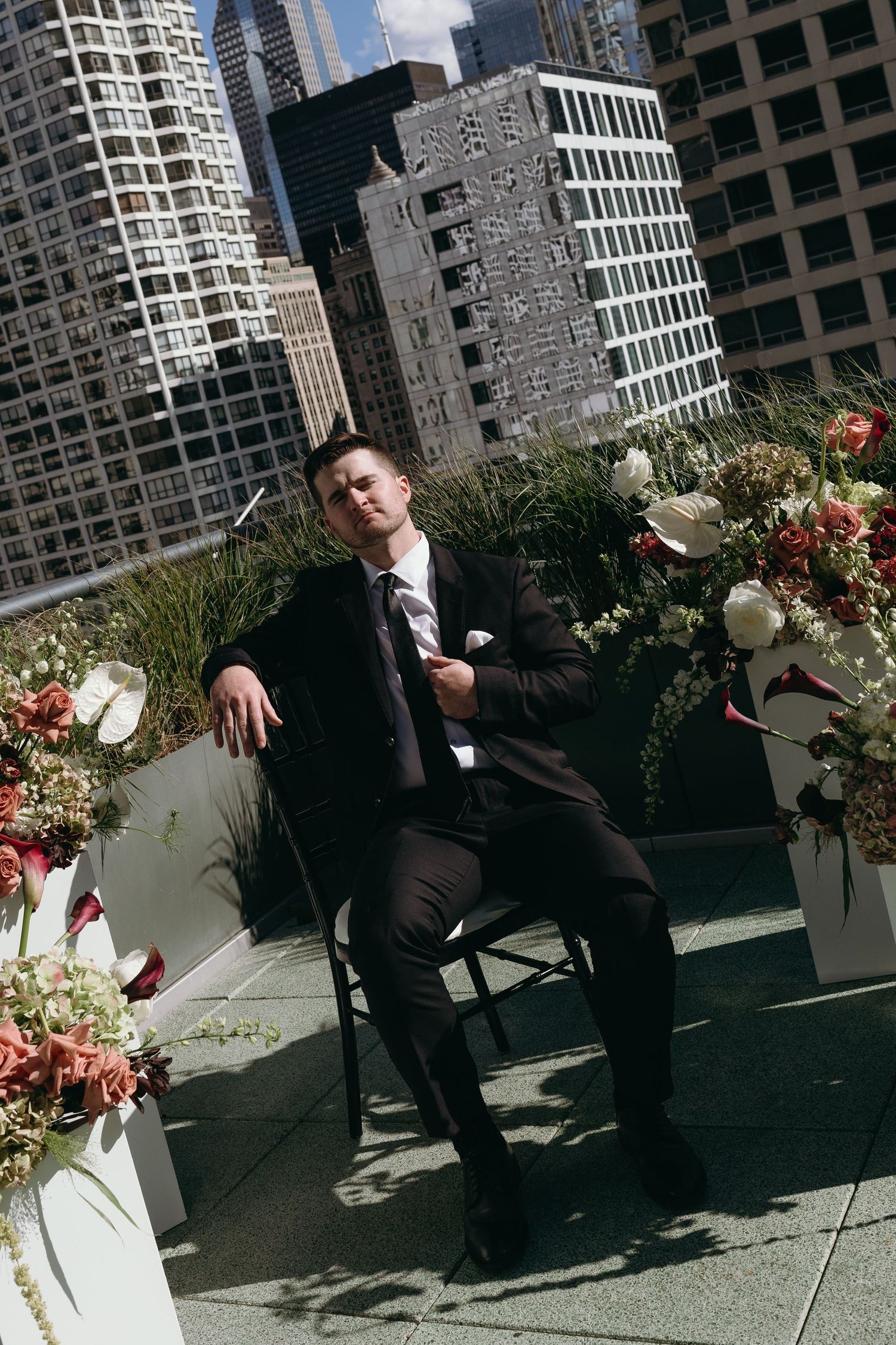 A sequence of photos showing someone in a suit lounging on outdoor patio furniture against an urban backdrop with skyscrapers.