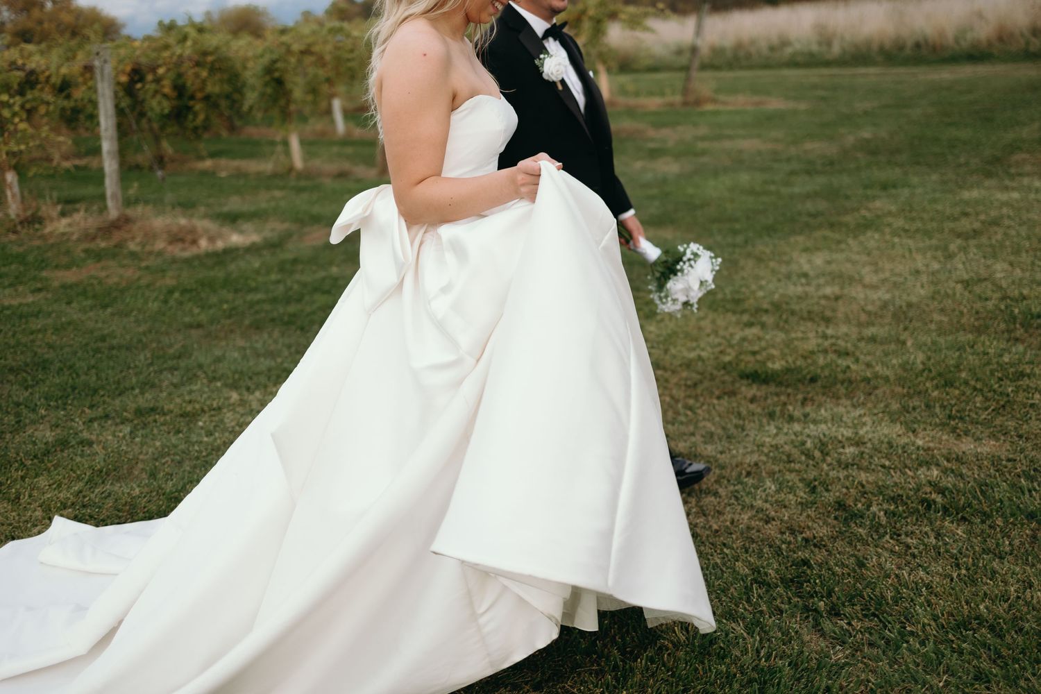 A bride and groom share a romantic moment in a vineyard during their fall wedding at Providence Vineyard in the Chicagoland