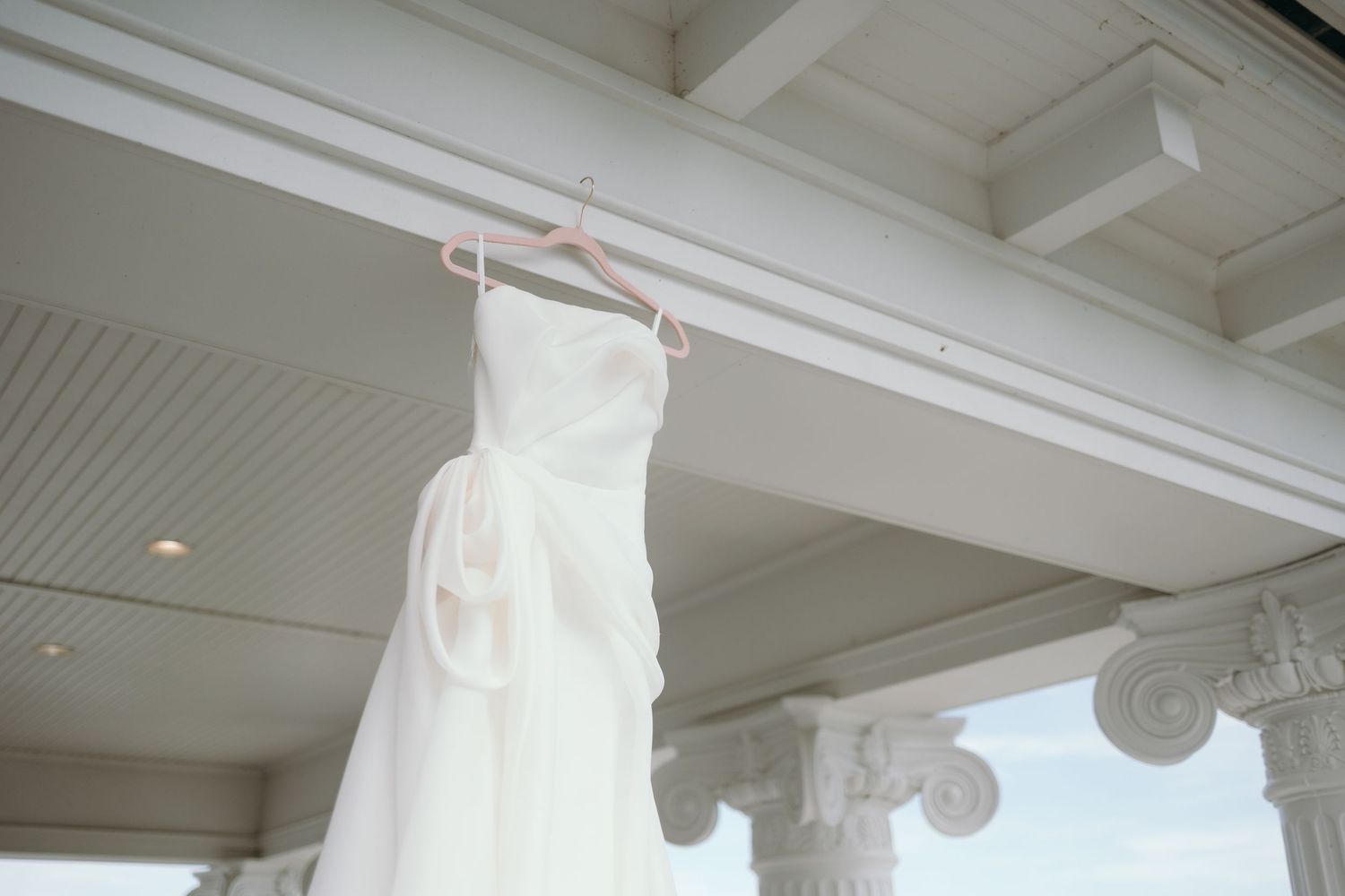 Decorative white crown molding details and architectural trim elements adorn a room with beige walls.