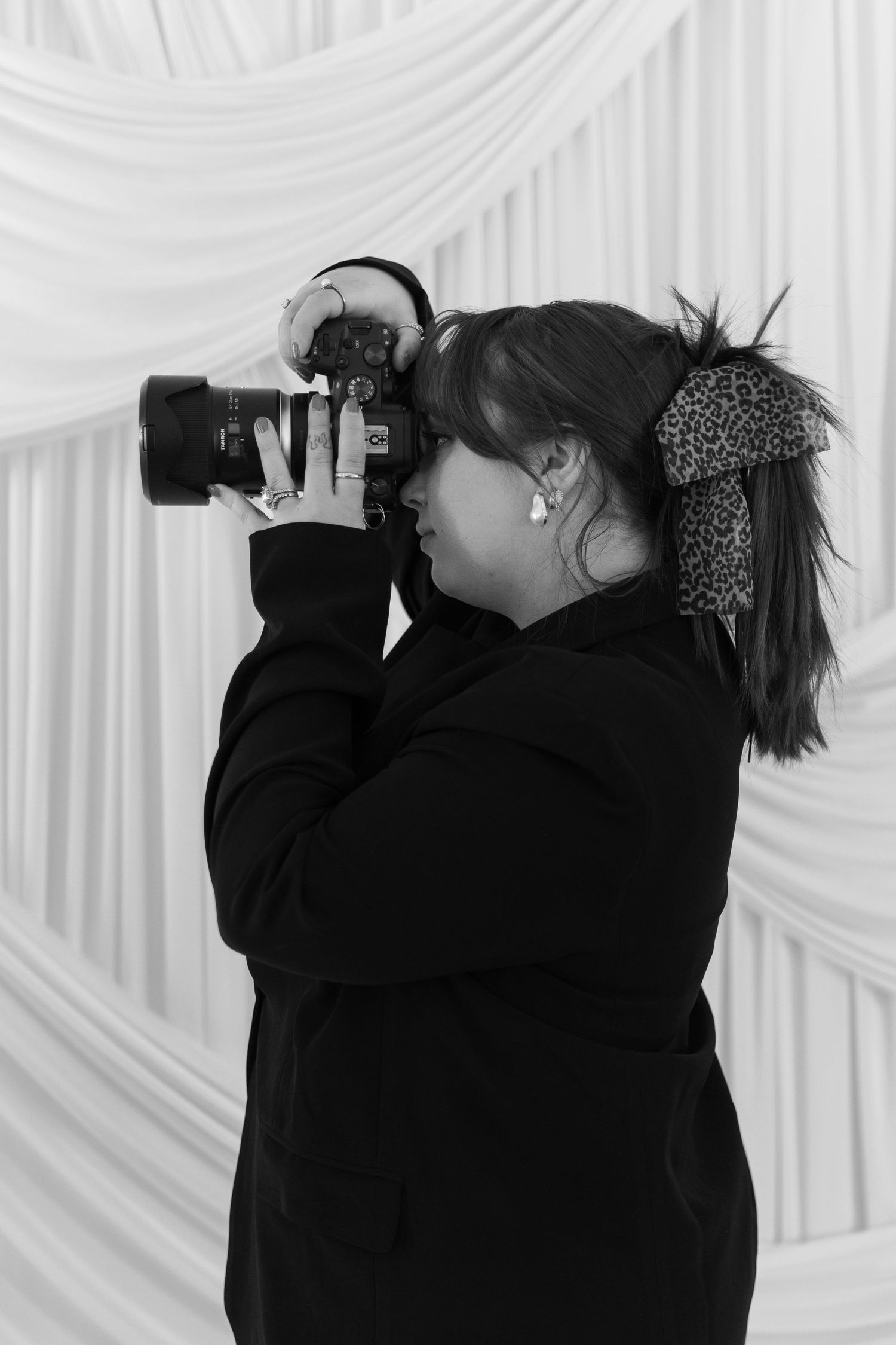 A sequence of black and white photos showing two people in dark clothing drinking from bottles against a white background.