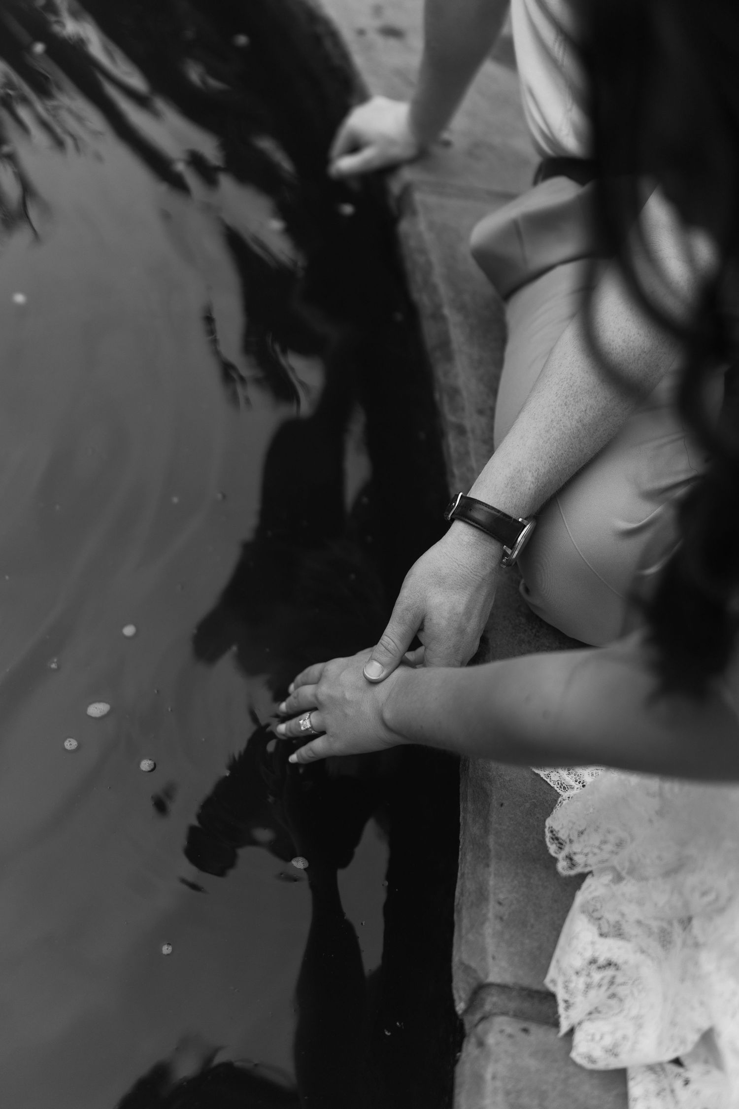 A black and white photo series showing hands preparing cut pieces of white lace fabric.