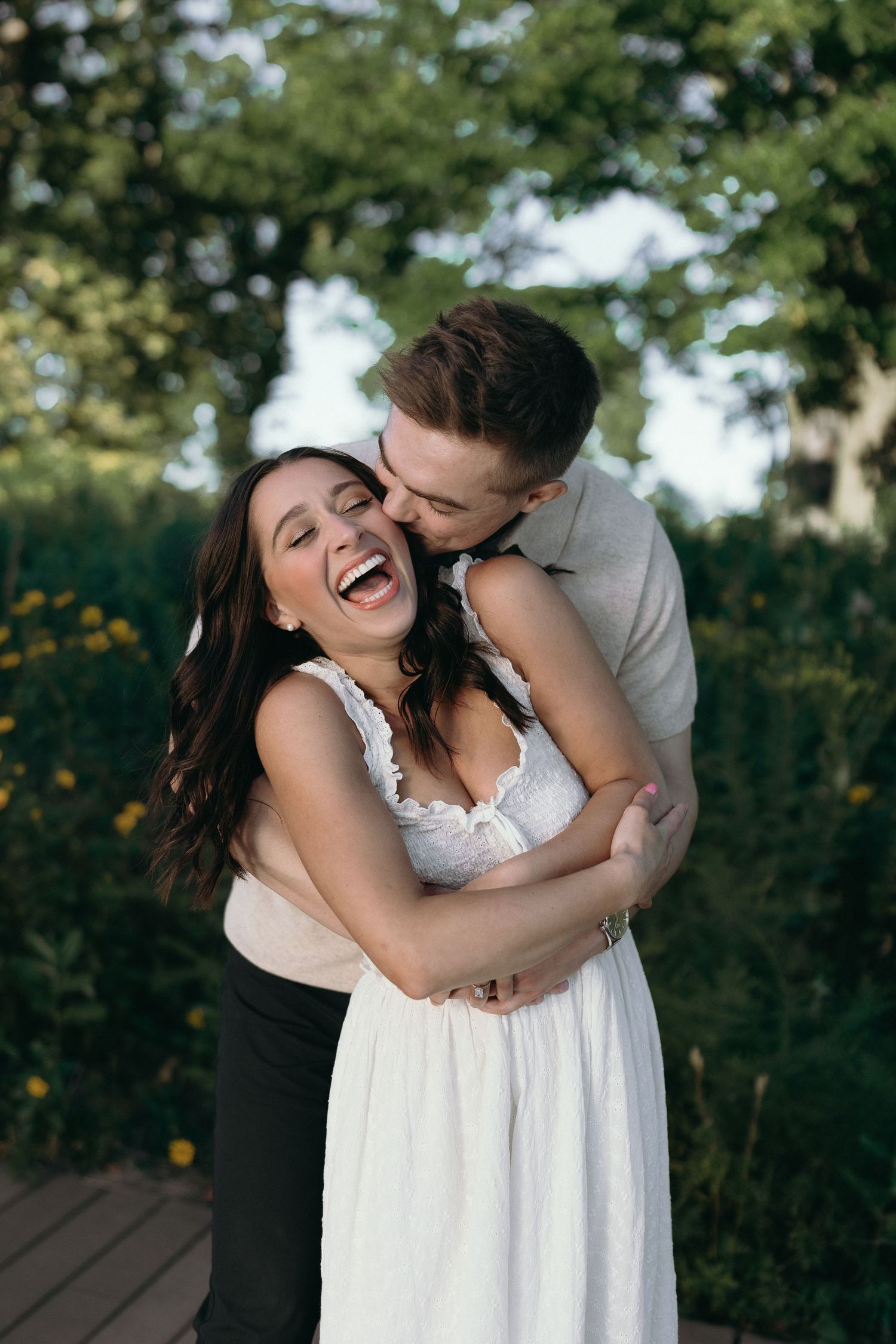 A joyful couple embraces and laughs together outdoors in a romantic series of candid photographs.