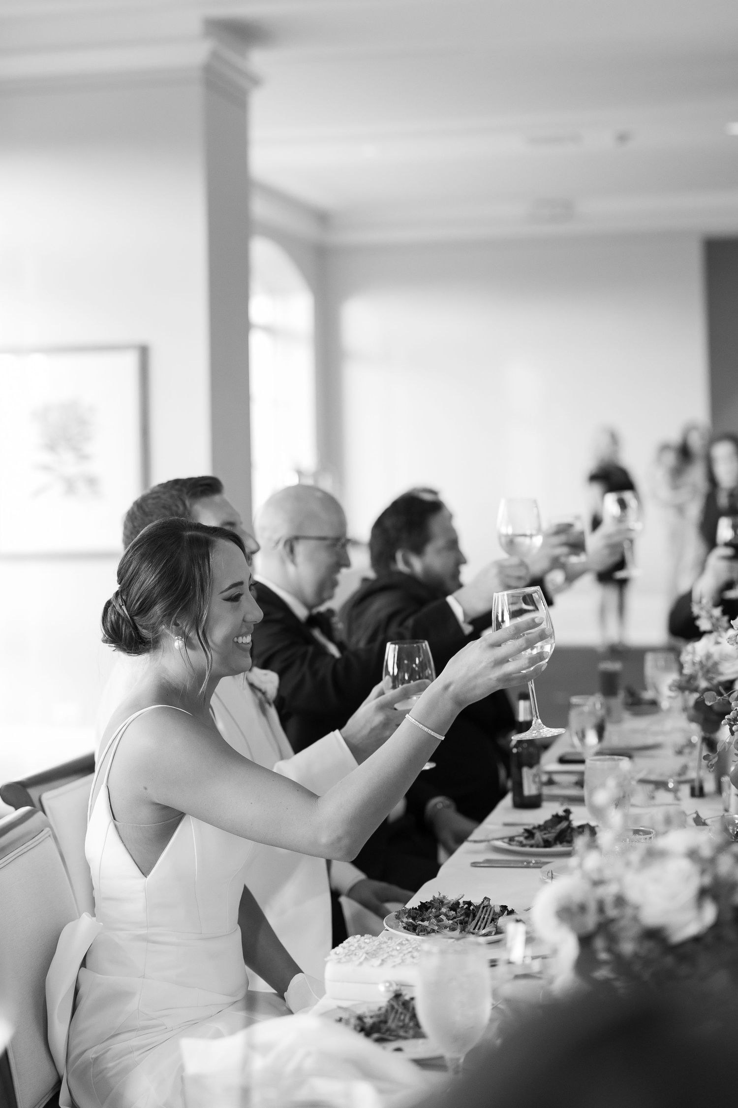 Guests enjoying a celebratory toast during an elegant indoor wedding reception.