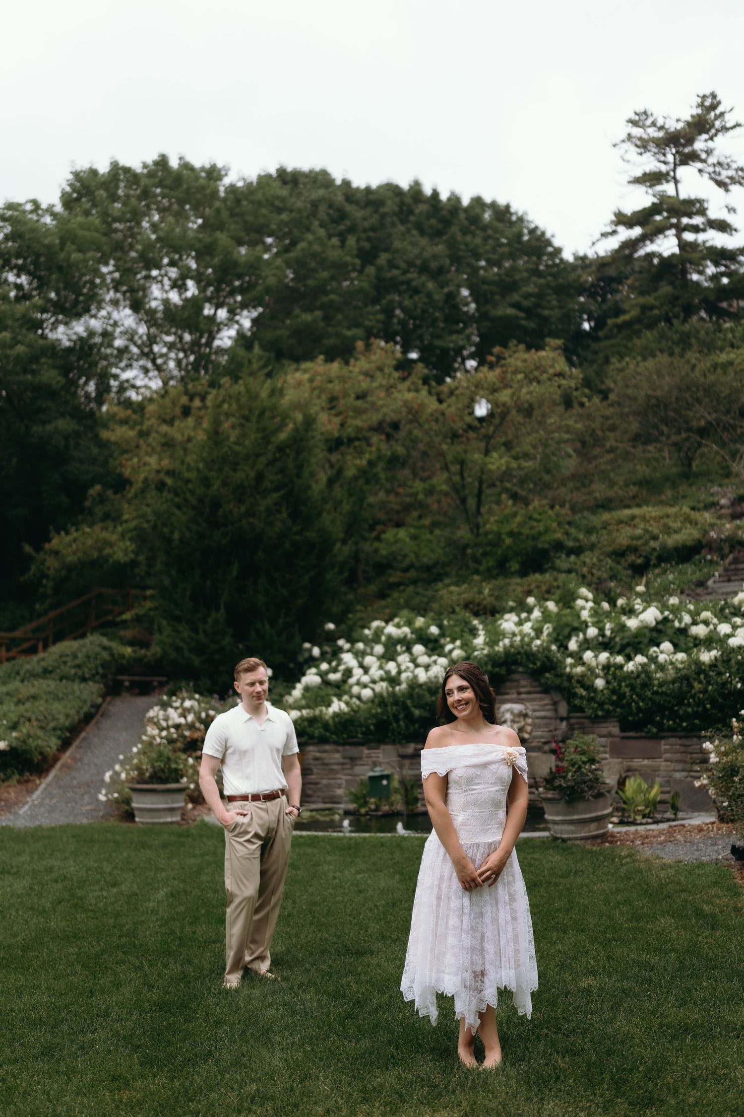 A romantic garden photo sequence showing a couple playfully walking through a lush outdoor setting surrounded by flowers and trees.