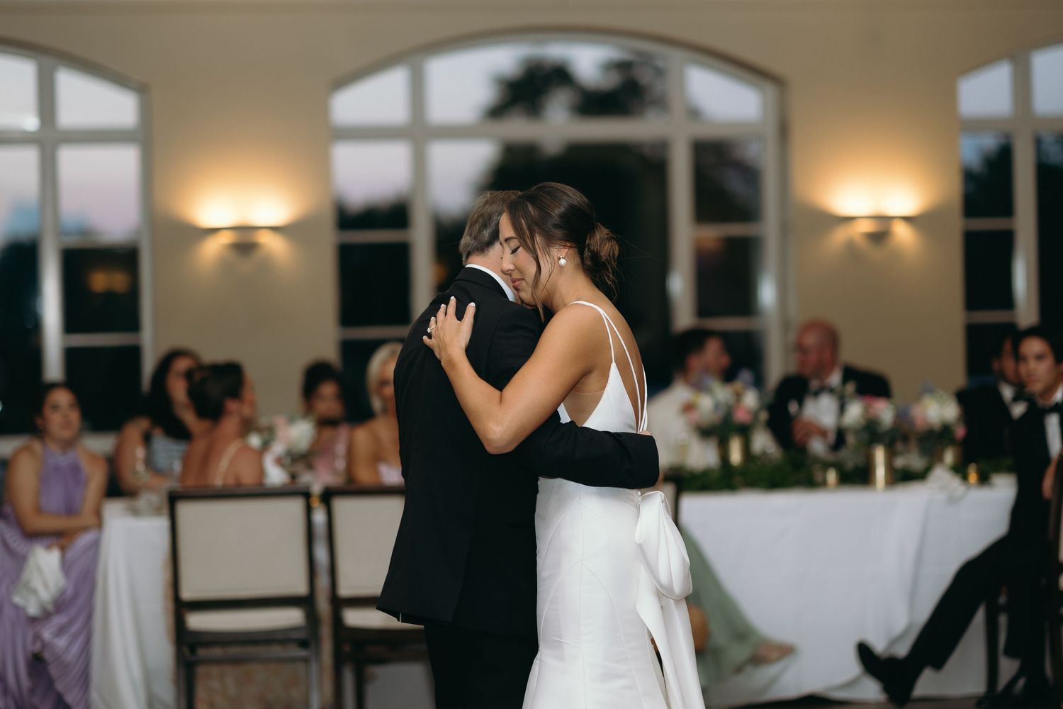 Couple dancing together in a romantic moment at an elegant reception venue.