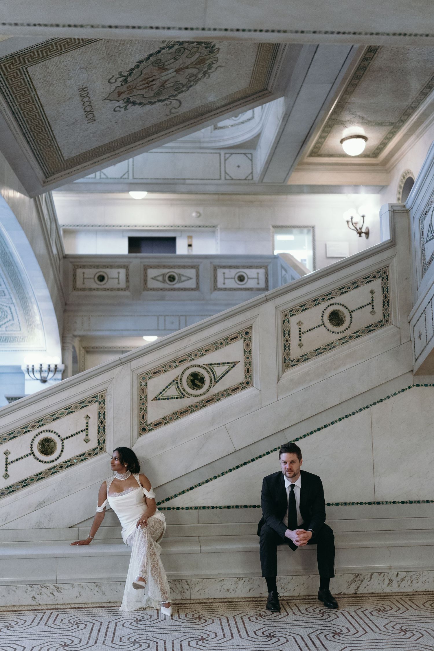 Artistic wedding photos in elegant white room with ornate ceiling details.