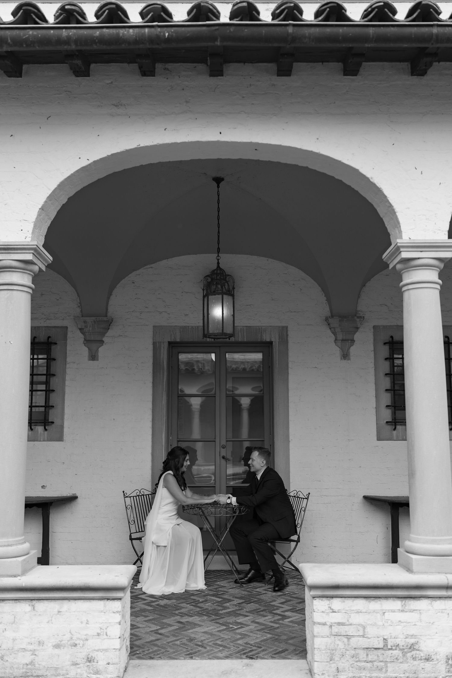 A black and white photo series showing a Spanish colonial style portico with arched walkways and columns at different angles.