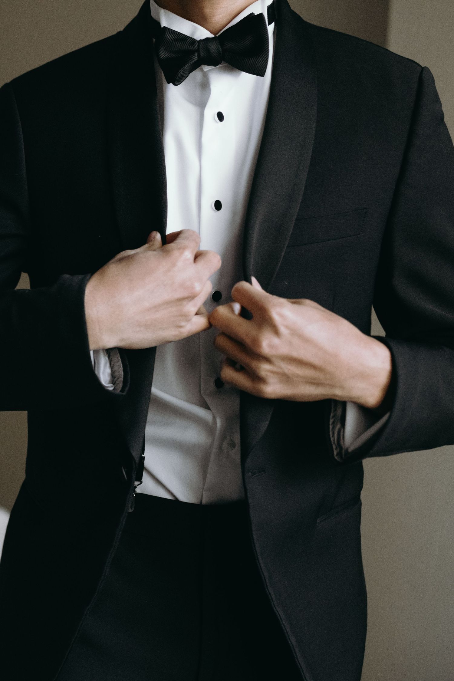 Classic black tuxedo with bow tie and white dress shirt detail.