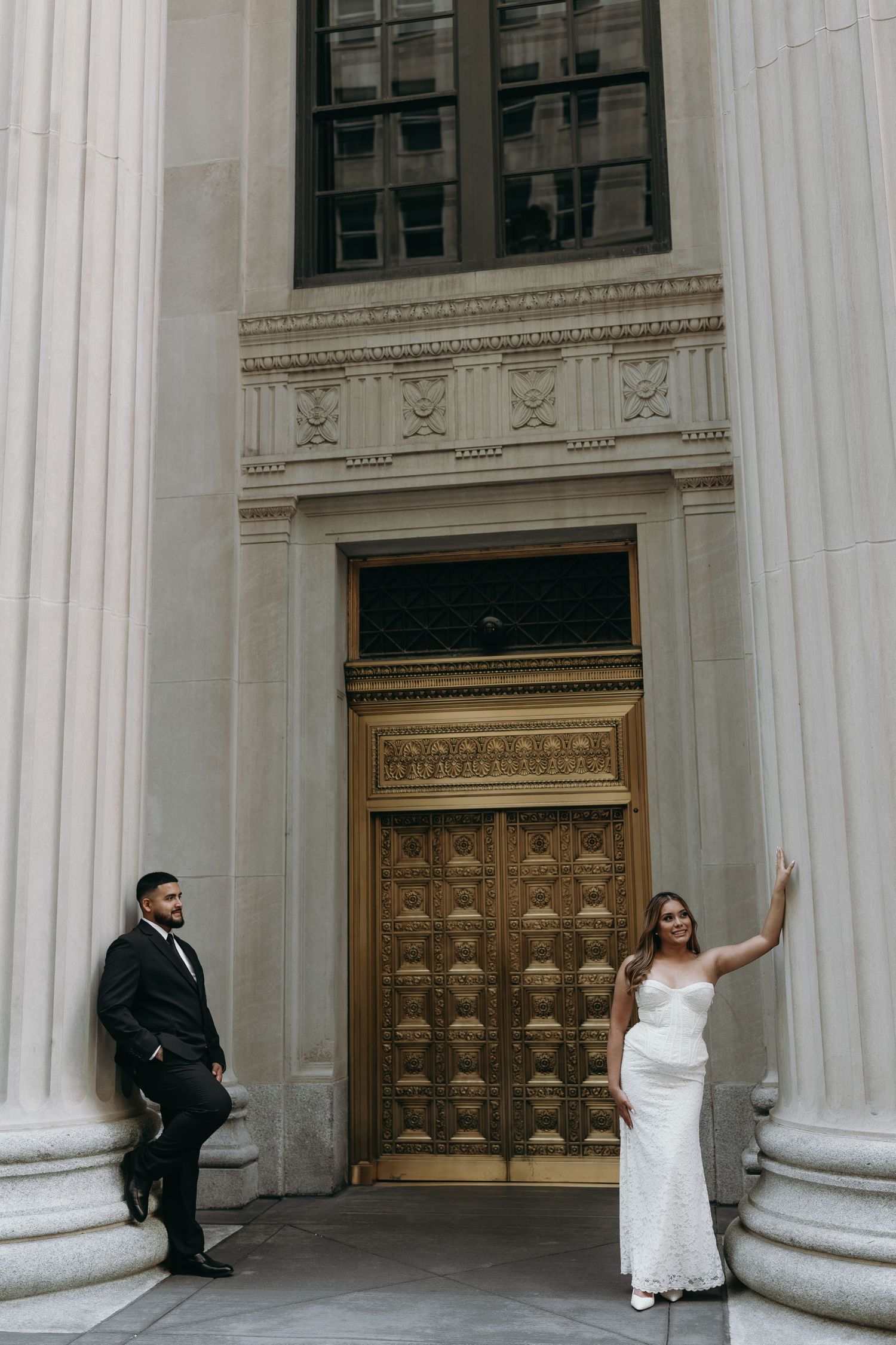 Engagement photos in Chicago in front of gold doors in the financial district