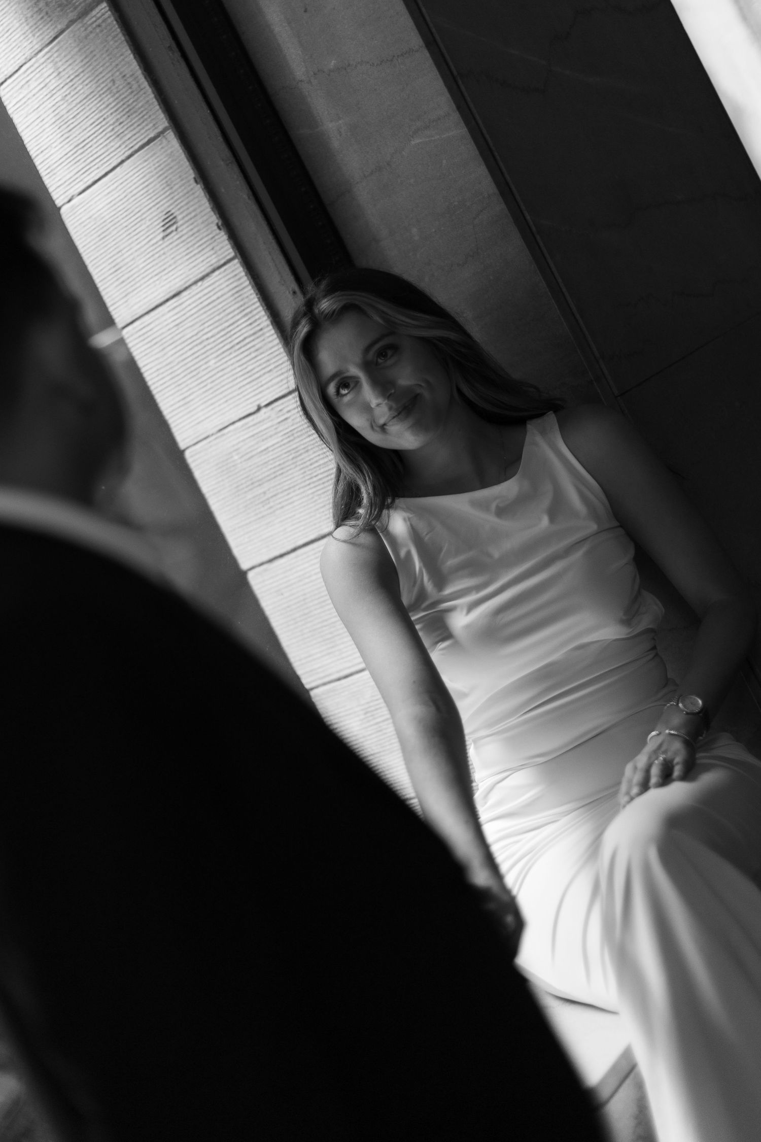 Black and white artistic photo series showing dramatic shadow play on a figure in a white dress against a wall.
