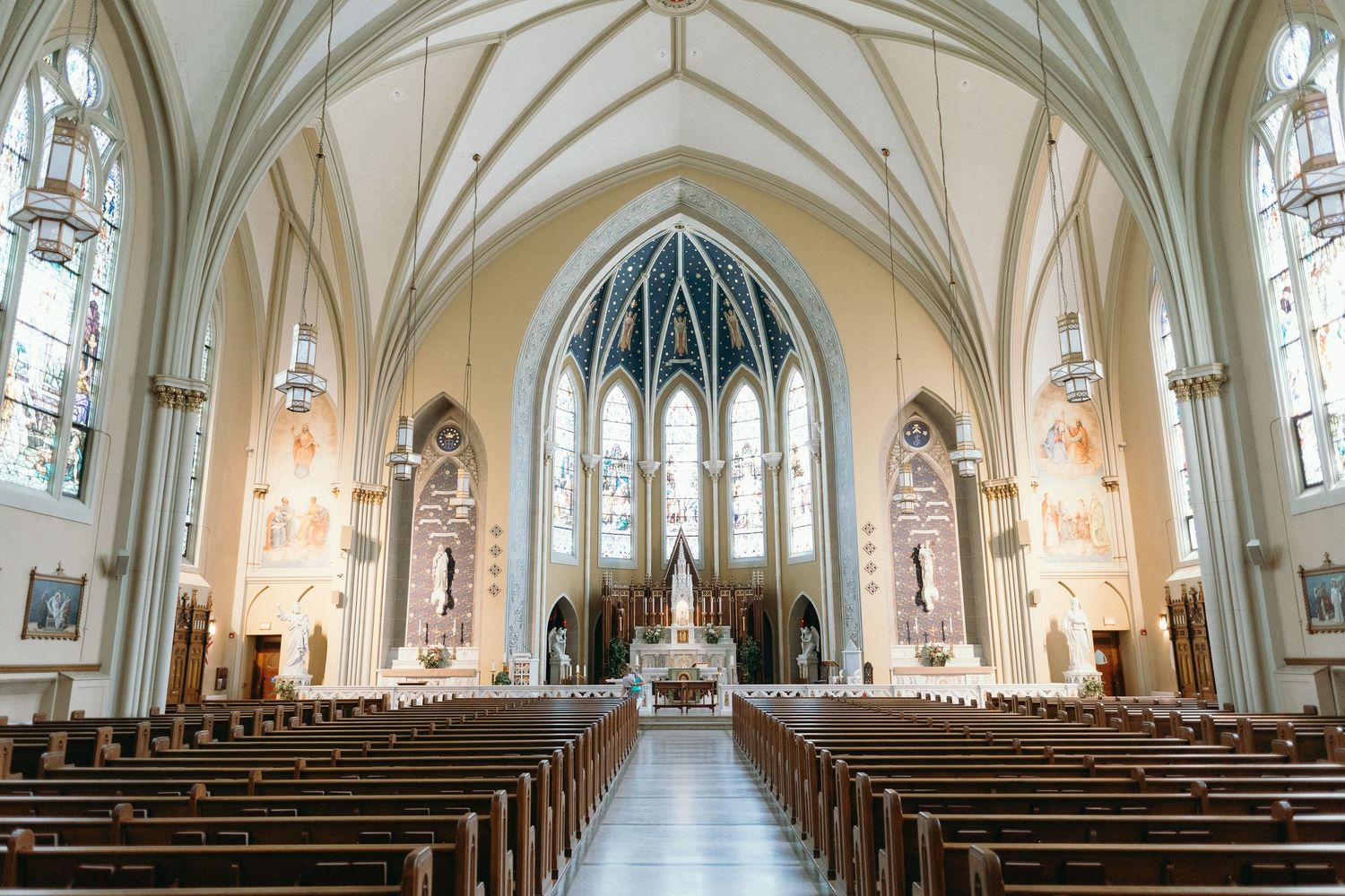 Interior of a Gothic cathedral with vaulted ceilings and stained glass windows.