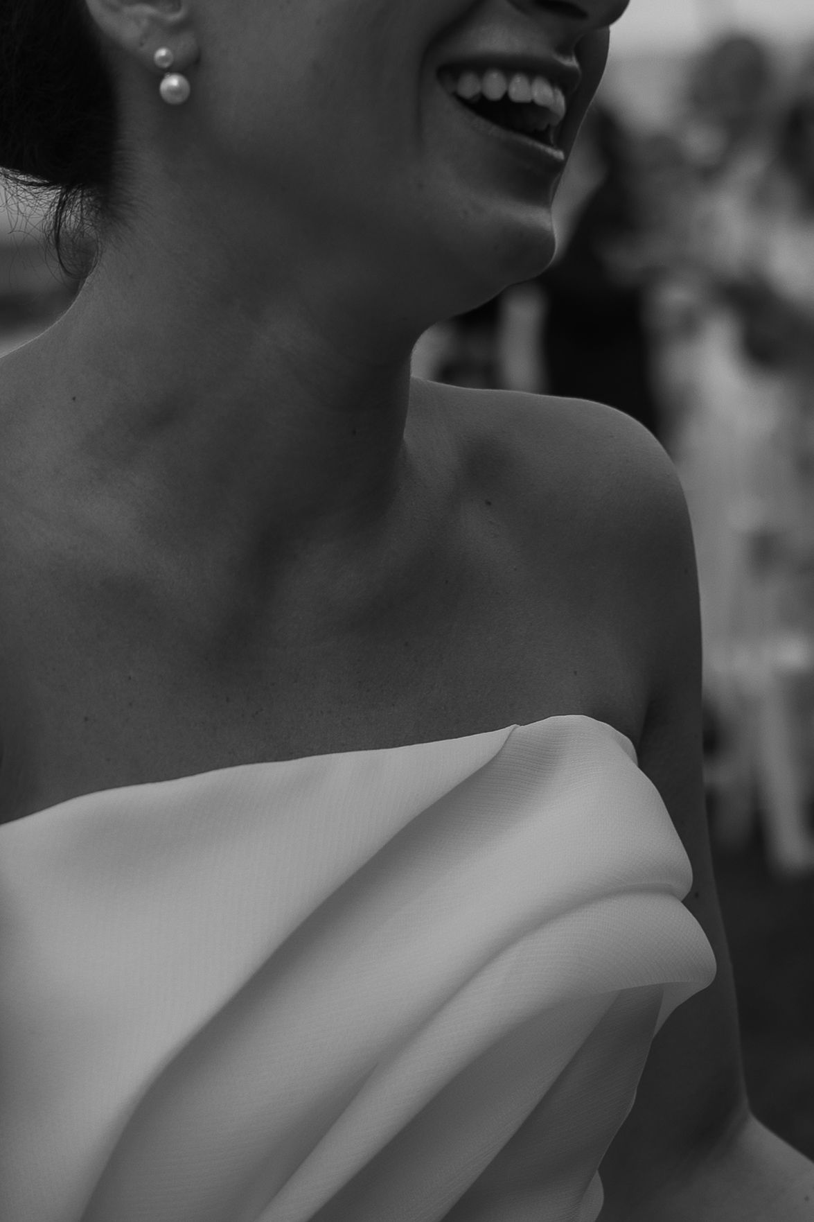 Black and white artistic profile photo with shallow depth of field and soft bokeh effect in the background.