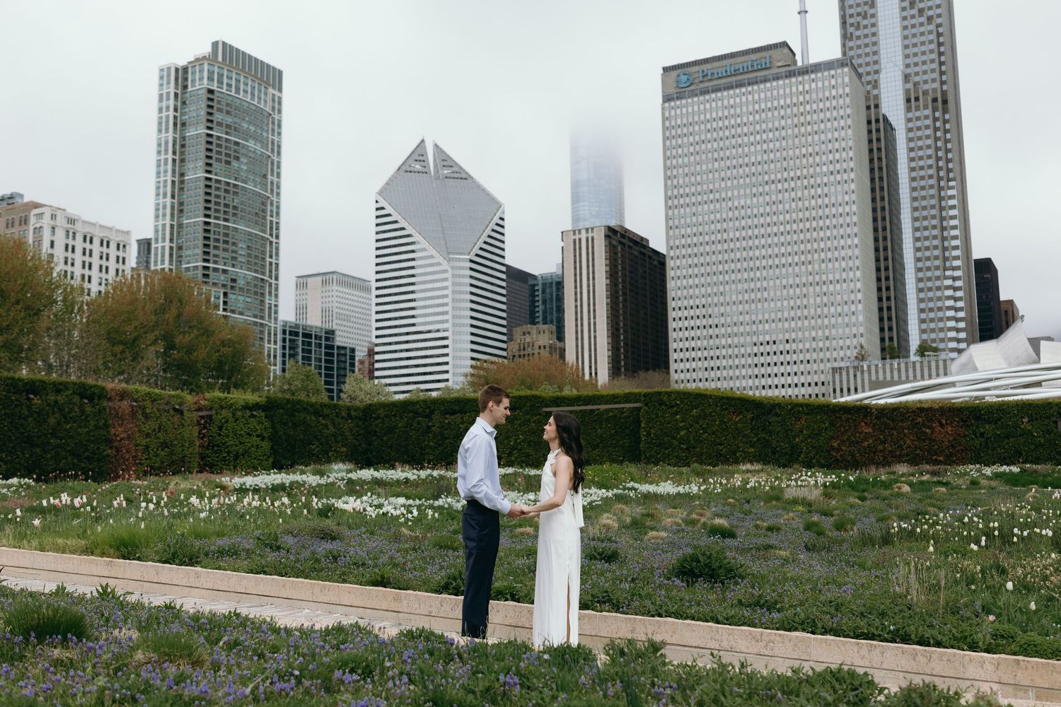 Scenic views of Chicago's Lurie Garden in Millennium Park with modern skyscrapers rising in the background engagement photos