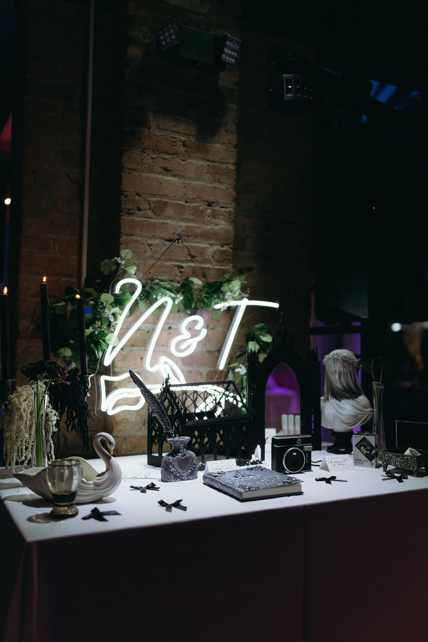 Wedding reception display featuring illuminated neon numbers and decorative elements.