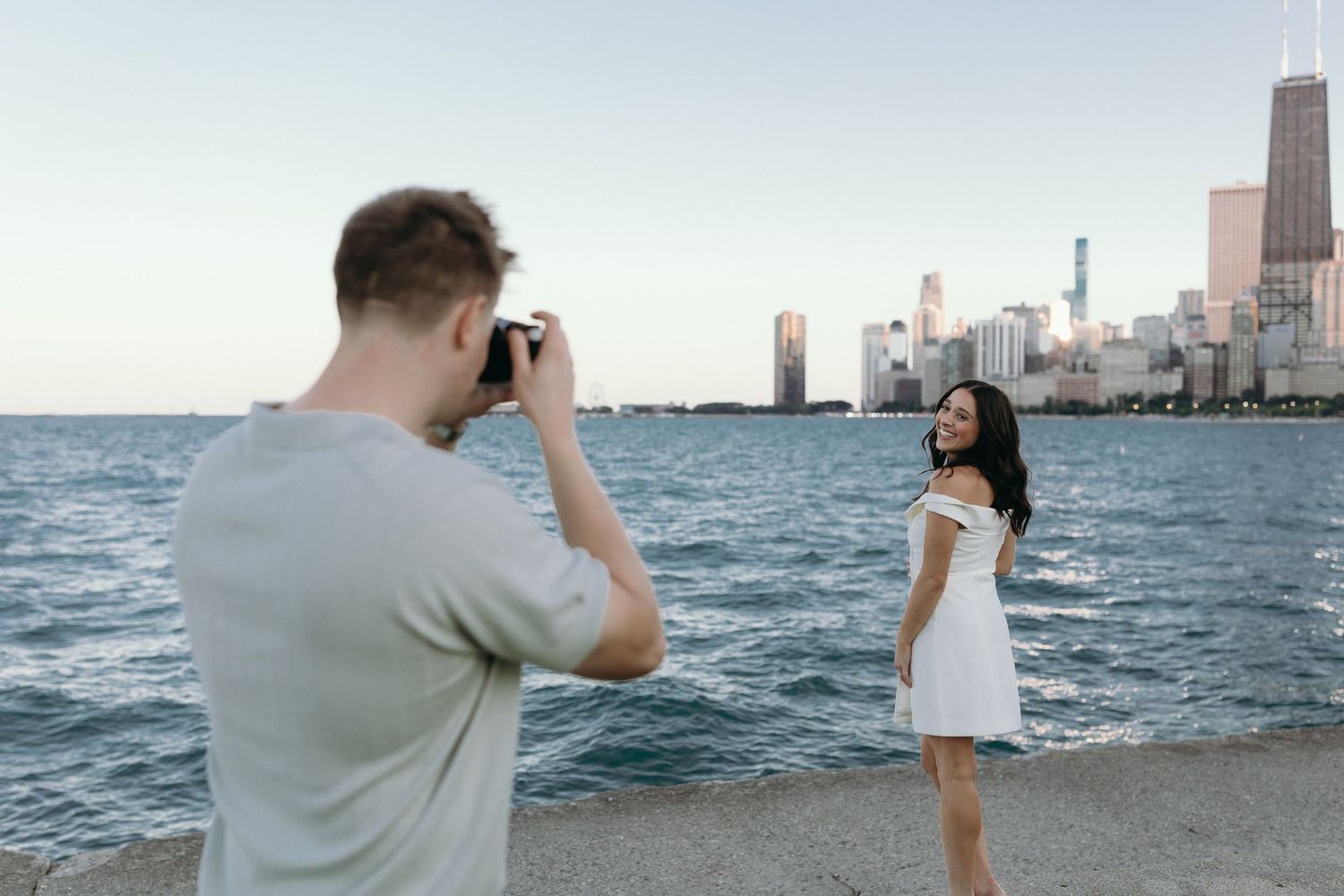 A series of six beachfront photos showing people taking pictures along Lake Michigan with Chicago's skyline in the background.
