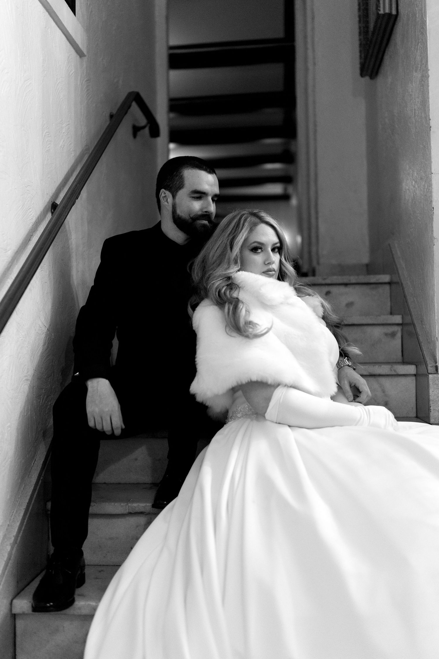 A romantic black and white wedding photo showing a couple in elegant attire embracing at Hotel Baker in the Chicagoland