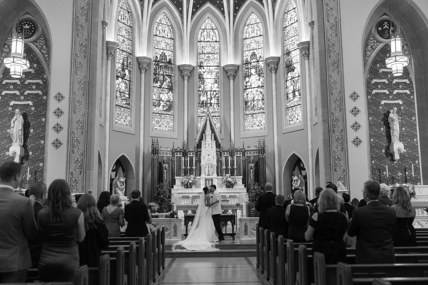 Interior view of a gothic cathedral church with high arched ceilings and stained glass windows.
