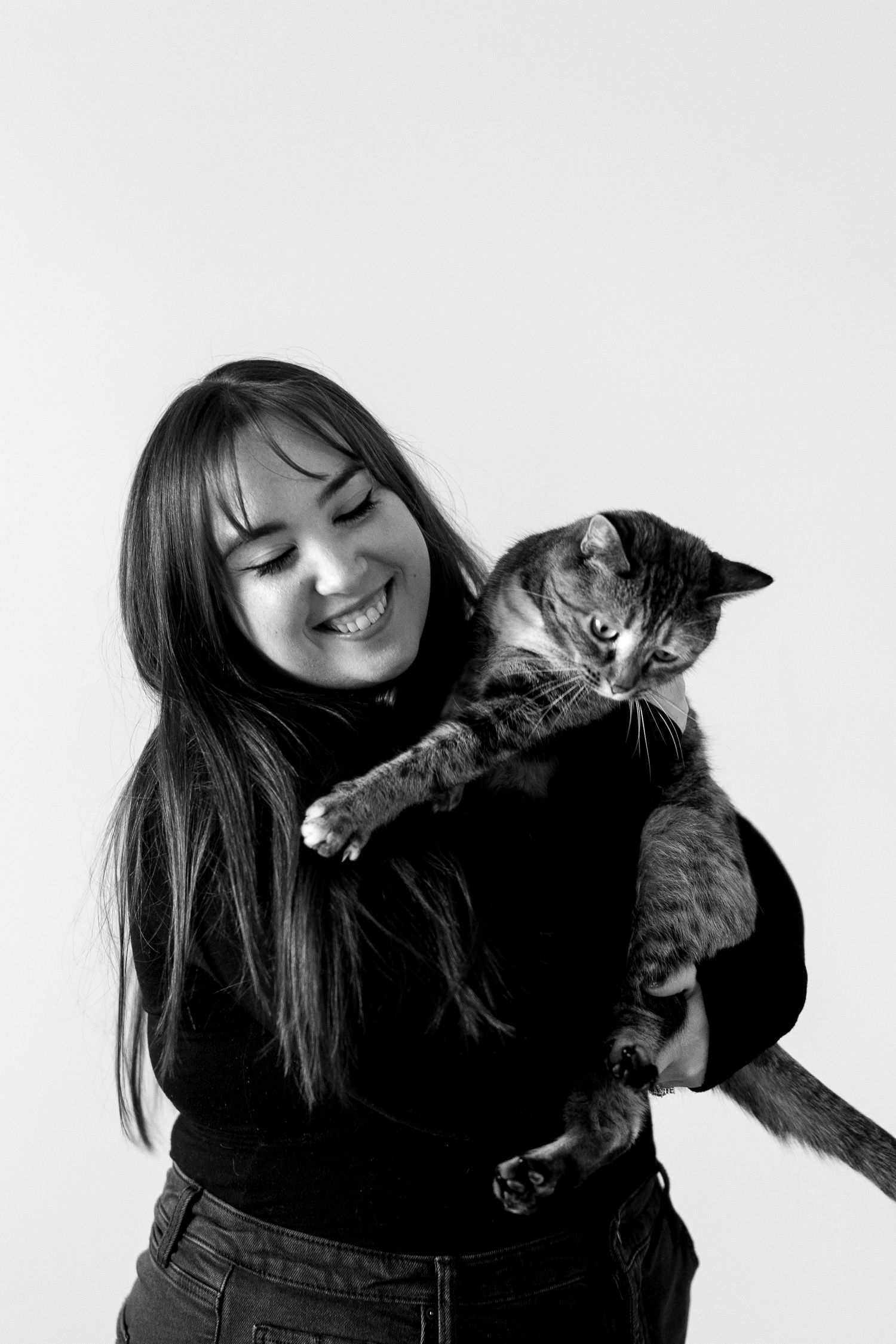 A heartwarming moment captured in black and white with a tabby cat.